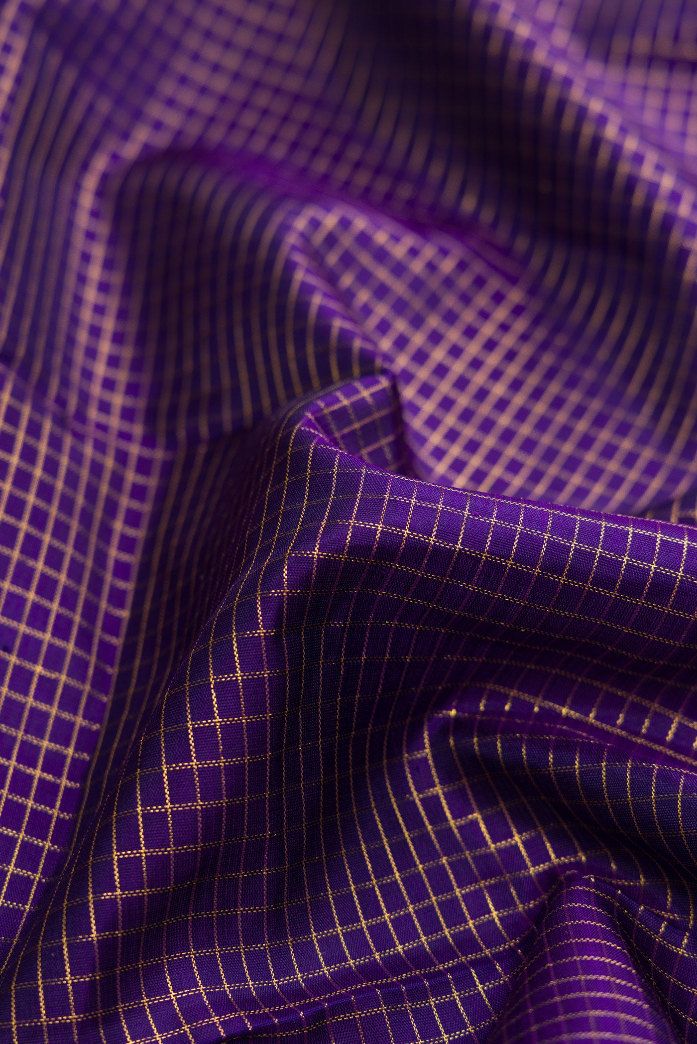 Close up of Navy Blue Dual Tone Kanchipuram Silk Saree with Checked design on the body and Zari Border.  displaying folds