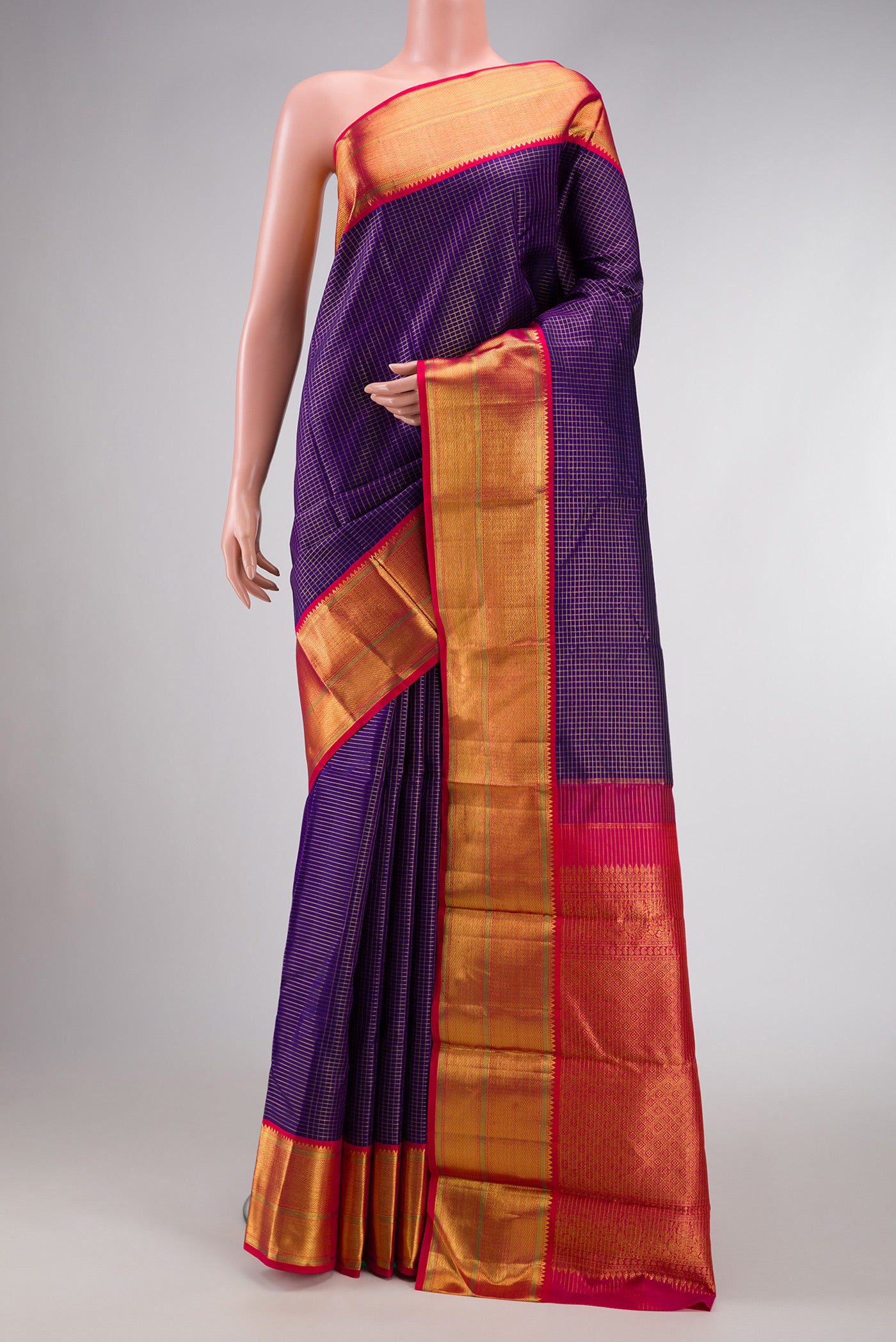 Navy Blue Dual Tone Kanchipuram Silk Saree with Checked design on the body and Zari Border.  displayed on a mannequin