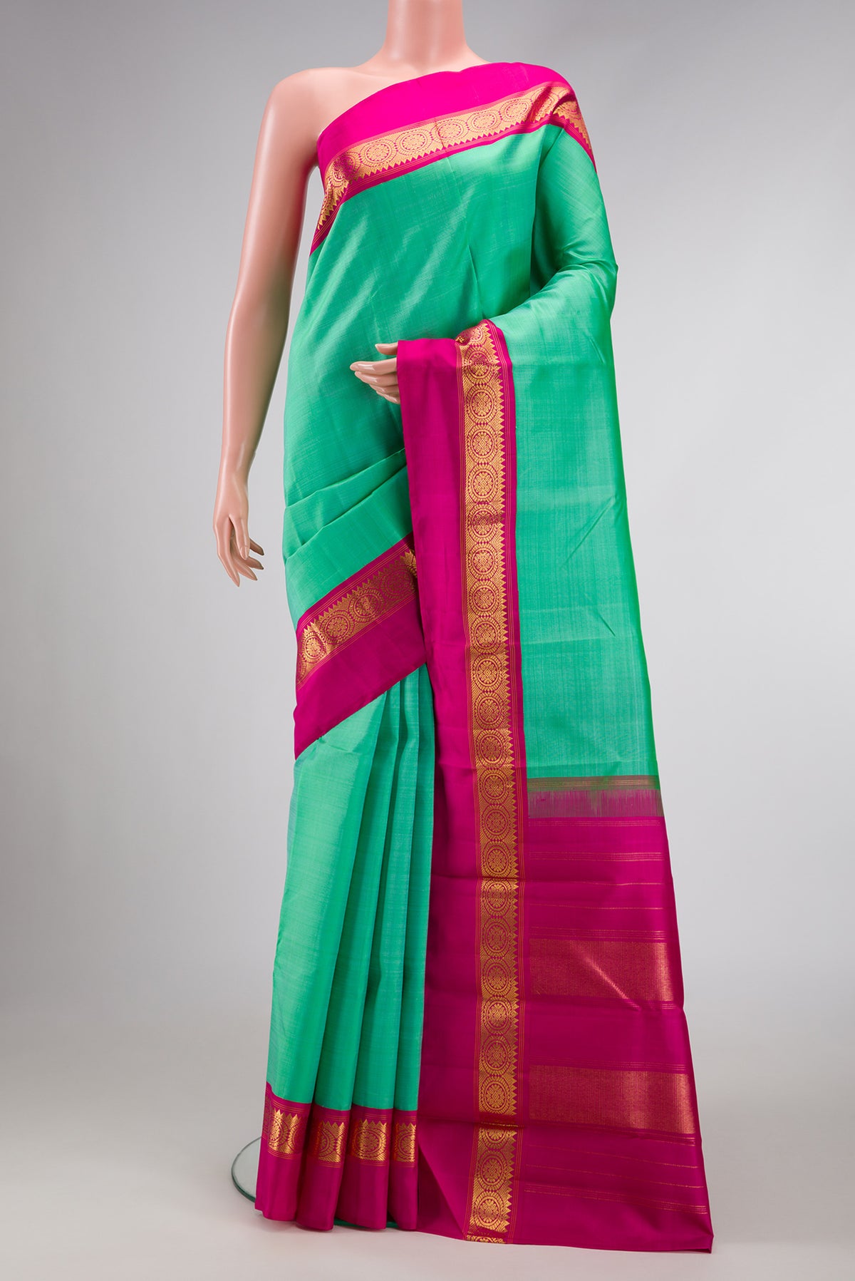 Pure Silk Pure Zari Sea Green Dual Tone Kanjivaram Saree with Plain Body and Zari Border.  displayed on a mannequin