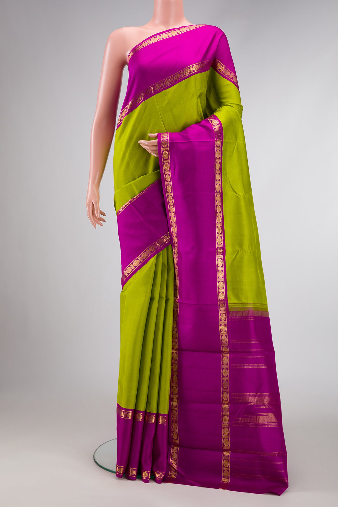 Parrot Green Dual Tone Kanjivaram Silk Saree with Plain Body and Zari Border.  displayed on a mannequin