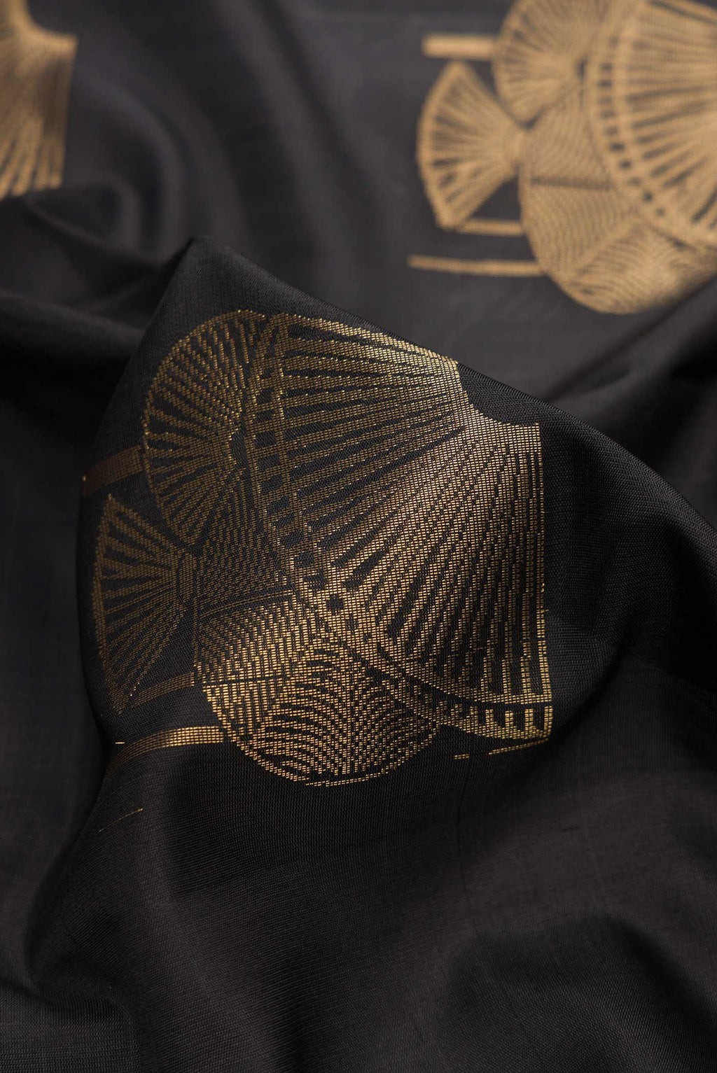 Close up of Black Dual Tone Soft Silk Saree with Zari Butta on the body and Without Border.  displaying folds