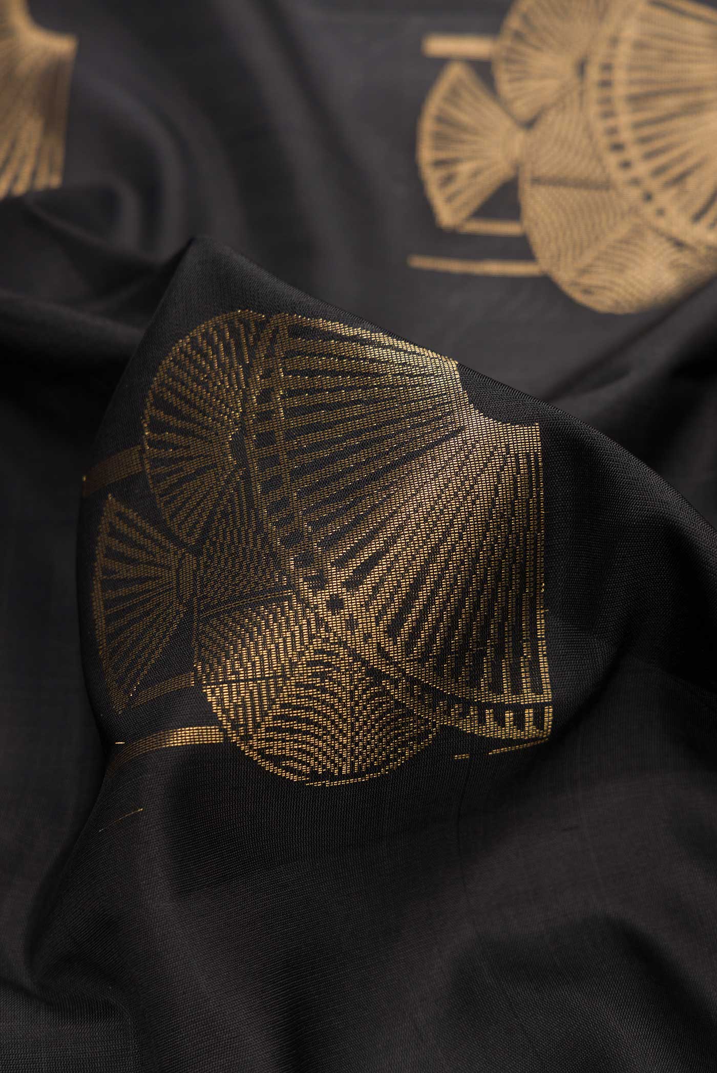 Close up of Black Dual Tone Soft Silk Saree with Zari Butta on the body and Without Border.  displaying folds