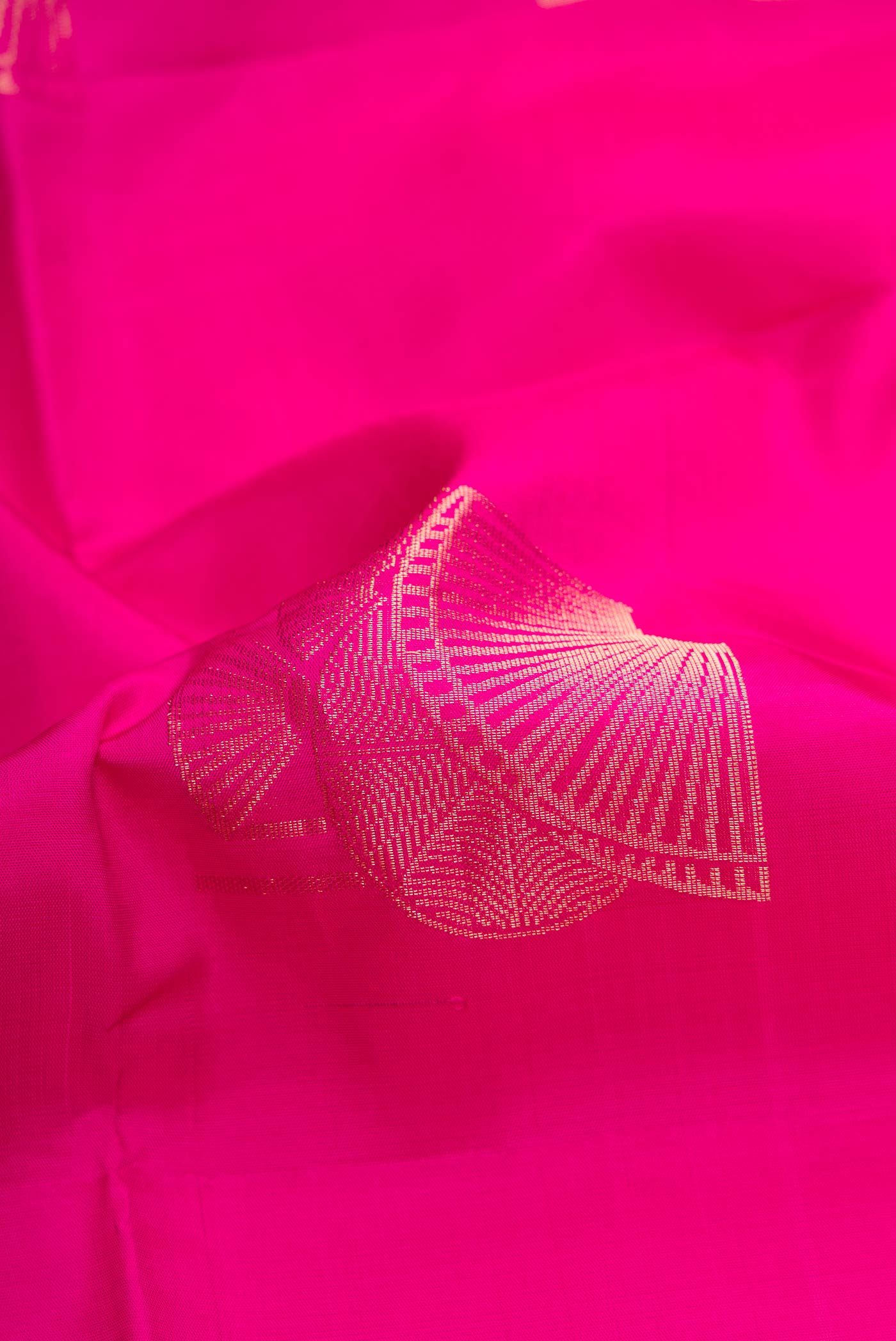 Close up of Pink Dual Tone Soft Silk Saree with Zari Butta on the body and Without Border.  displaying folds