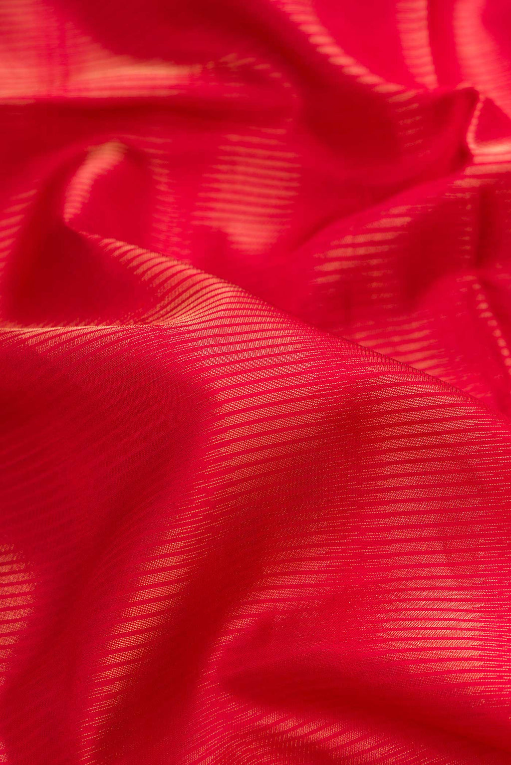 Close up of Red Dual Tone Soft Silk Saree with Zari Brocade on the body and Zari Border.  displaying folds