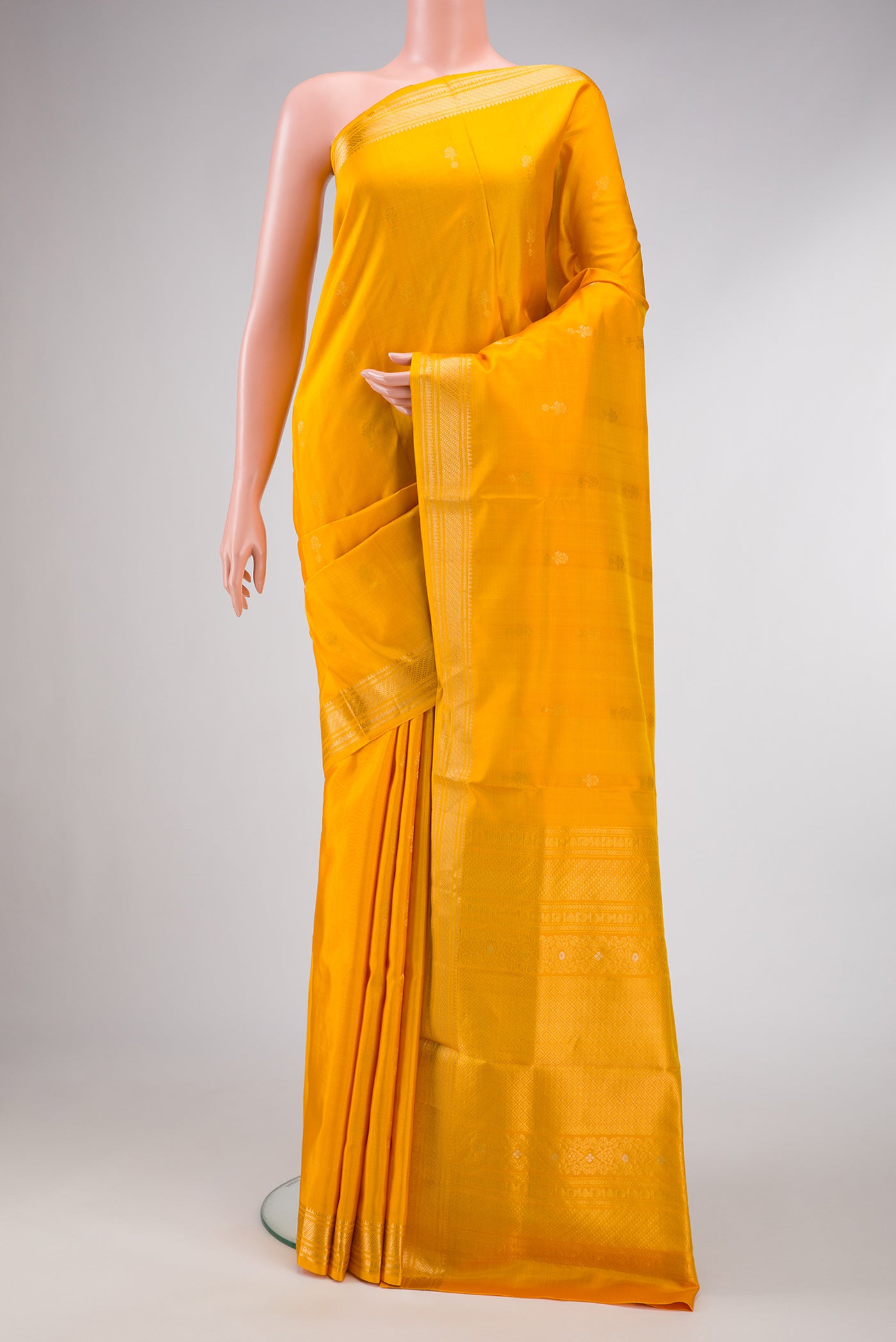 Yellow Dual Tone Soft Silk Saree with Zari Butta on the body and Zari Border.  displayed on a mannequin