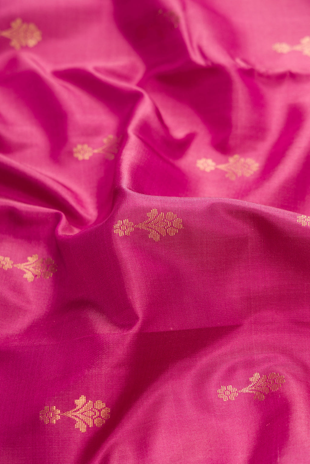 Close up of Pink Dual Tone Soft Silk Saree with Zari Butta on the body and Zari Border.  displaying folds