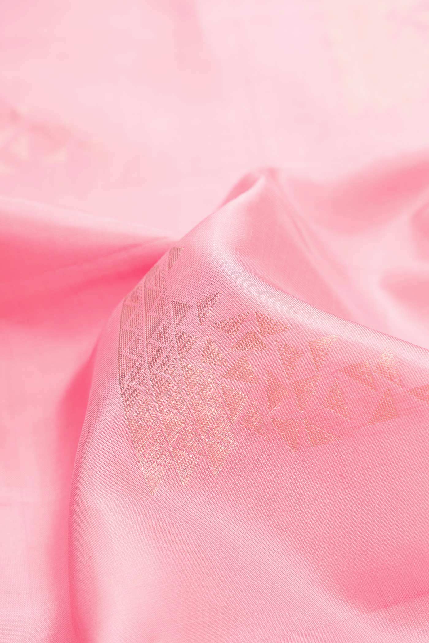 Close up of Pink Dual Tone Soft Silk Saree with Zari Butta on the body and Zari Border.  displaying folds