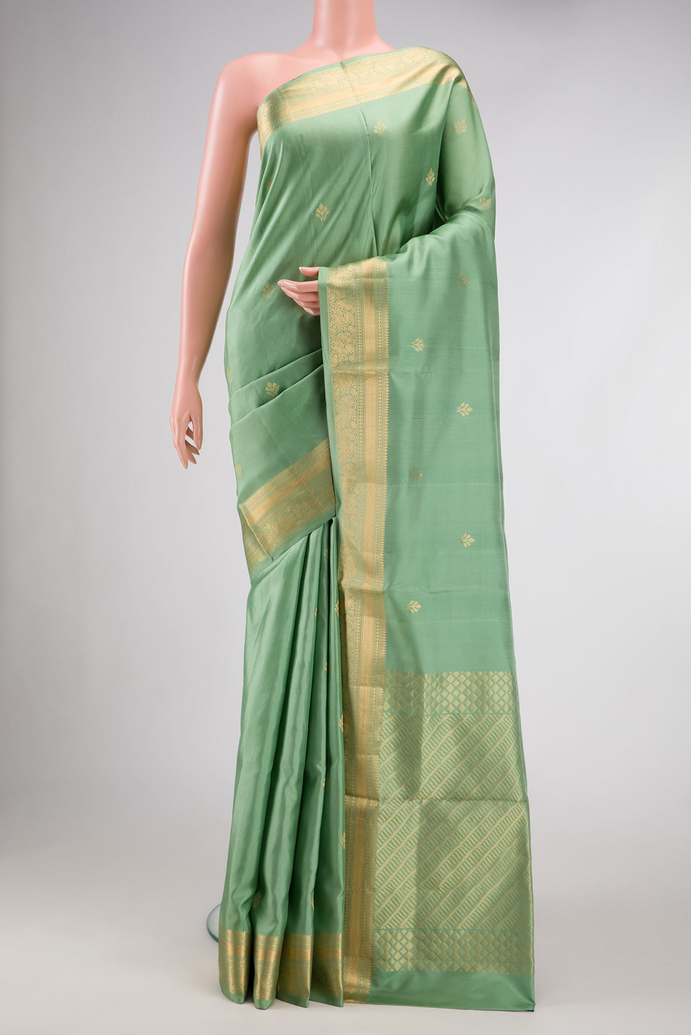 Pista Green Dual Tone Soft Silk Saree with Zari Butta on the body and Zari Border.  displayed on a mannequin