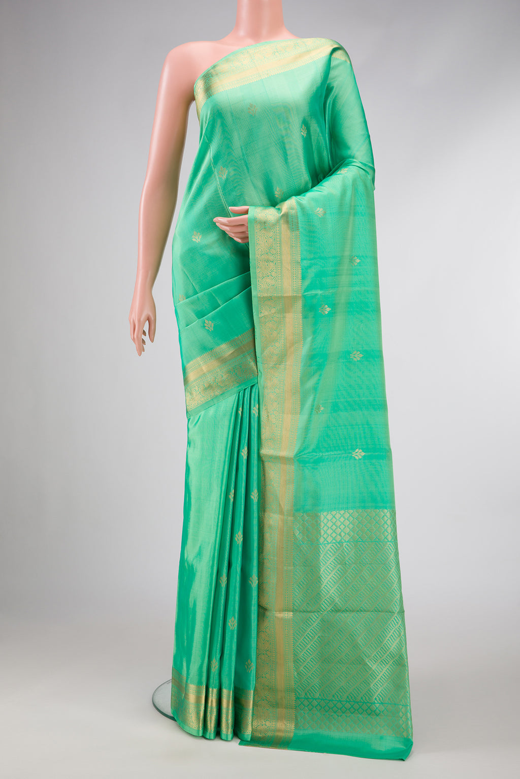 Parrot Green Dual Tone Soft Silk Saree with Zari Butta on the body and Zari Border.  displayed on a mannequin