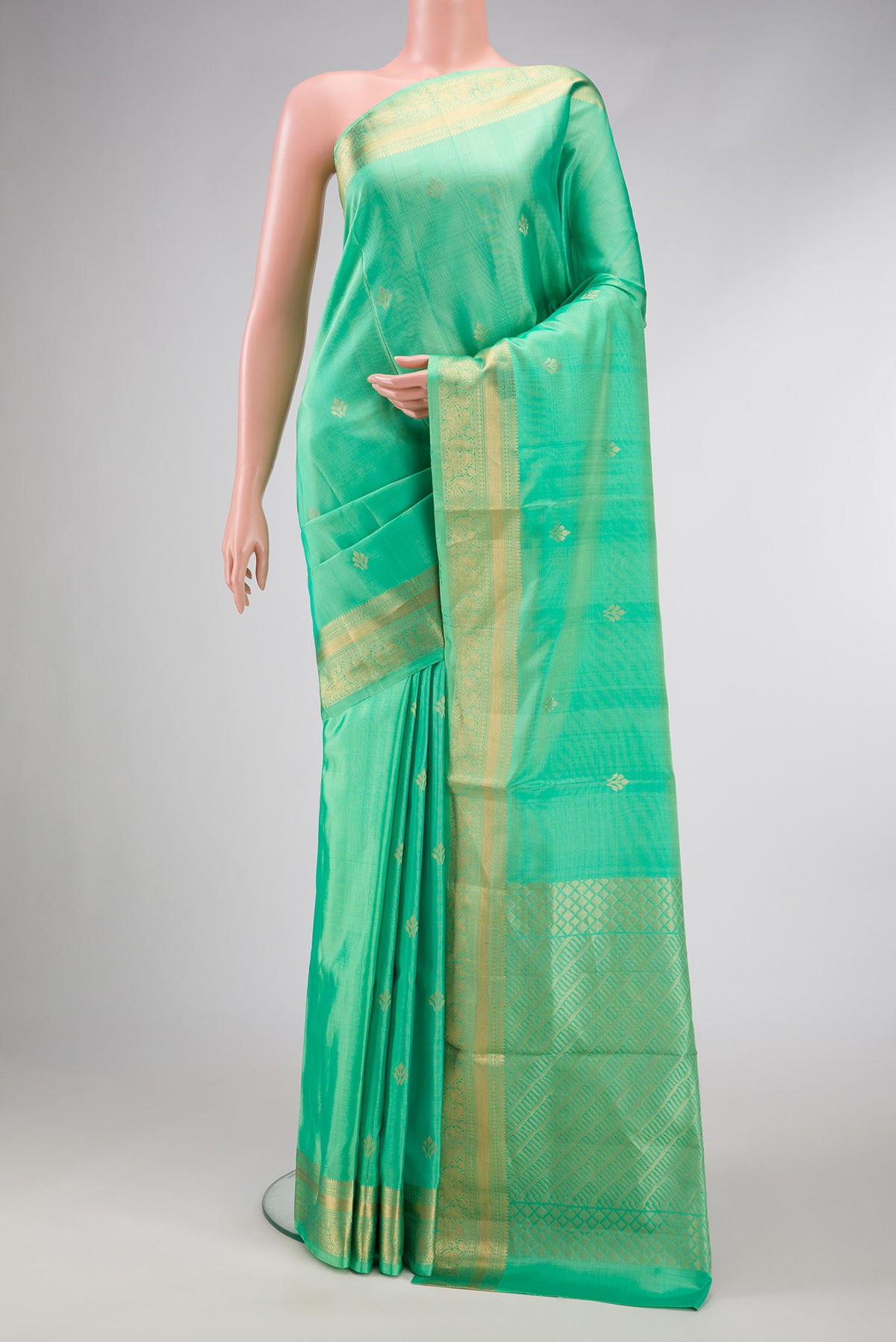 Parrot Green Dual Tone Soft Silk Saree with Zari Butta on the body and Zari Border.  displayed on a mannequin