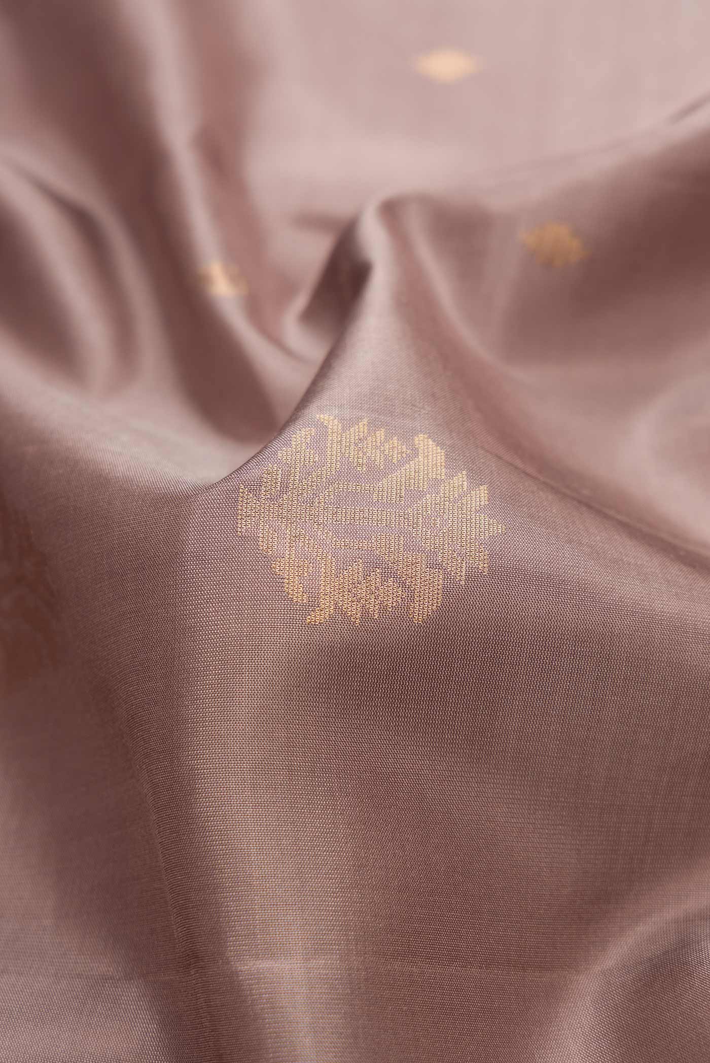 Close up of Brown Dual Tone Soft Silk Saree with Zari Butta on the body and Zari Border.  displaying folds