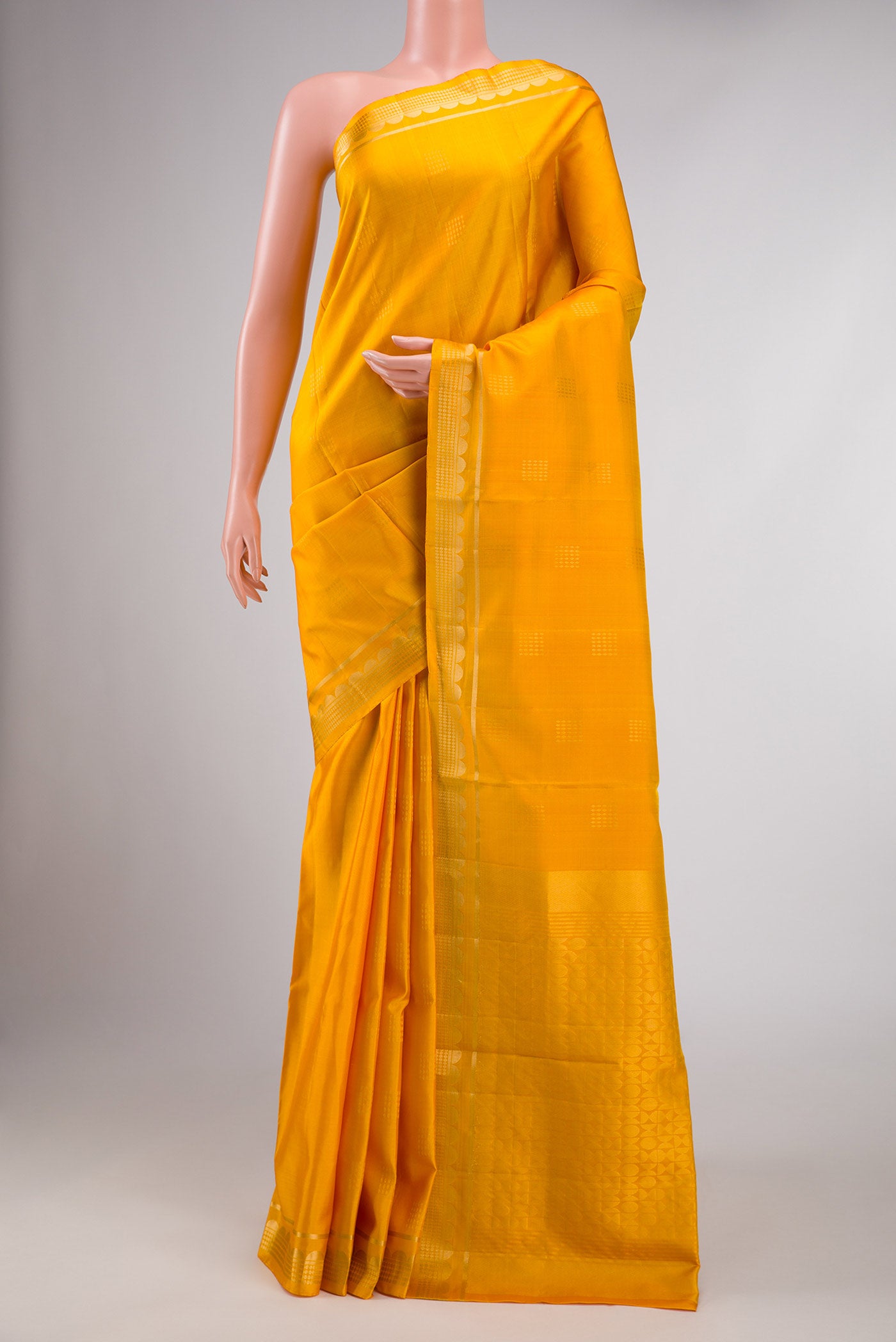 Yellow Dual Tone Soft Silk Saree with Zari Butta on the body and Zari Border displayed on a mannequin
