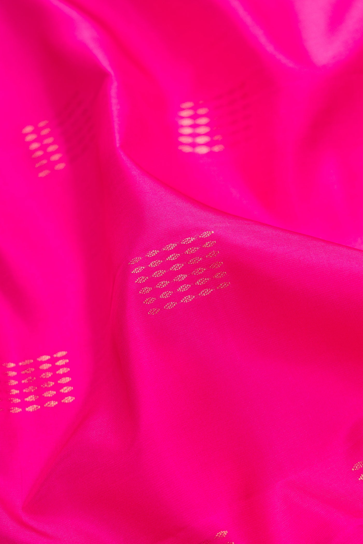 Close up of Pink Dual Tone Soft Silk Saree with Zari Butta on the body and Fancy Border.  displaying folds