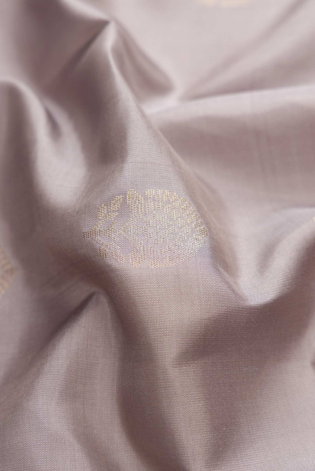 Close up of Grey Dual Tone Soft Silk Saree with Zari Butta on the body and Zari Border displaying folds