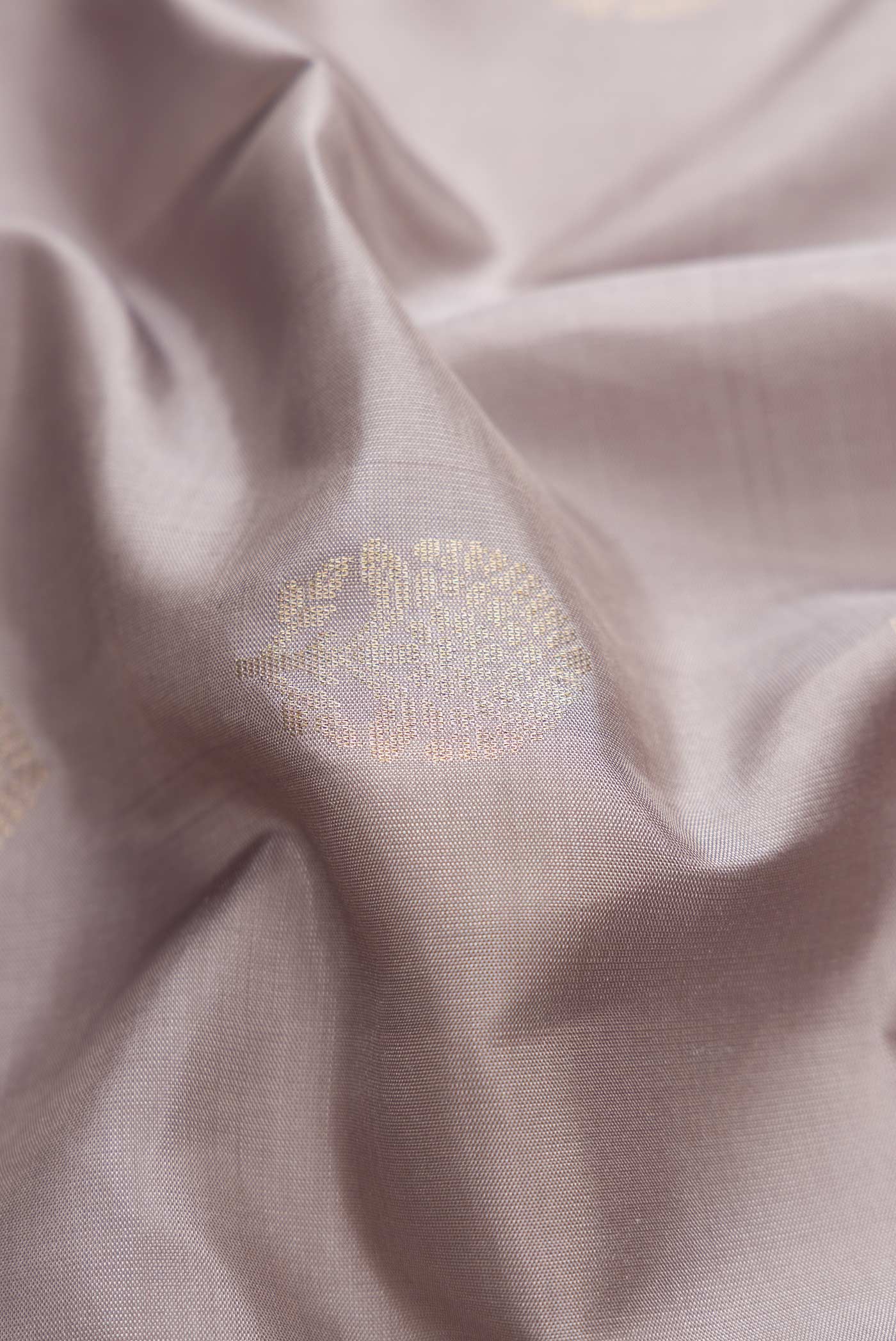 Close up of Grey Dual Tone Soft Silk Saree with Zari Butta on the body and Zari Border displaying folds