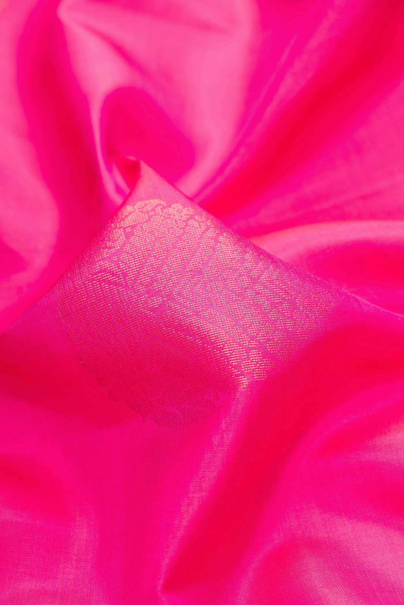 Close up of Pink Dual Tone Soft Silk Saree with Zari Butta on the body and Zari Border.  displaying folds