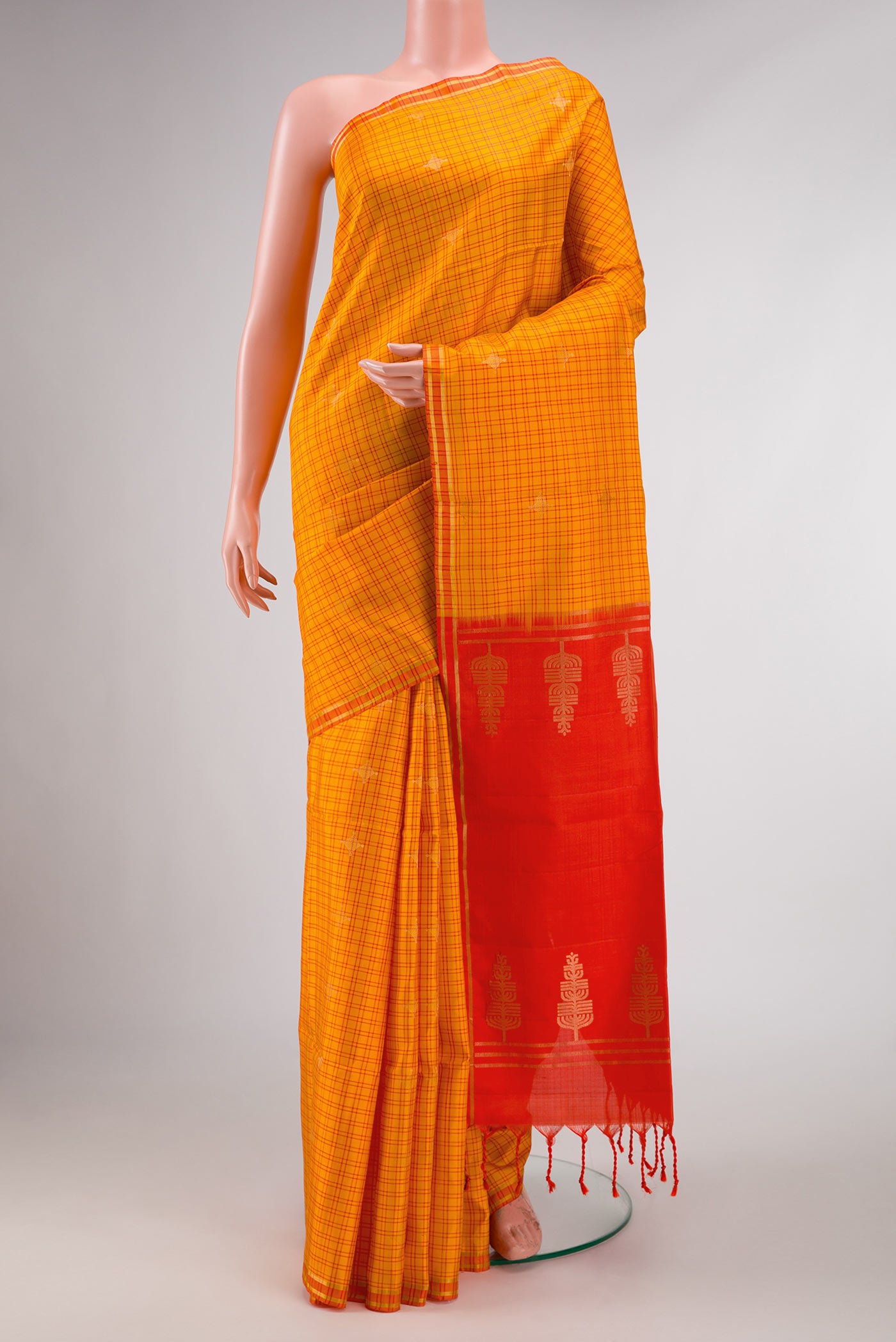 Yellow Soft Silk Saree with Checked design on the body and Thin Zari Line displayed on a mannequin