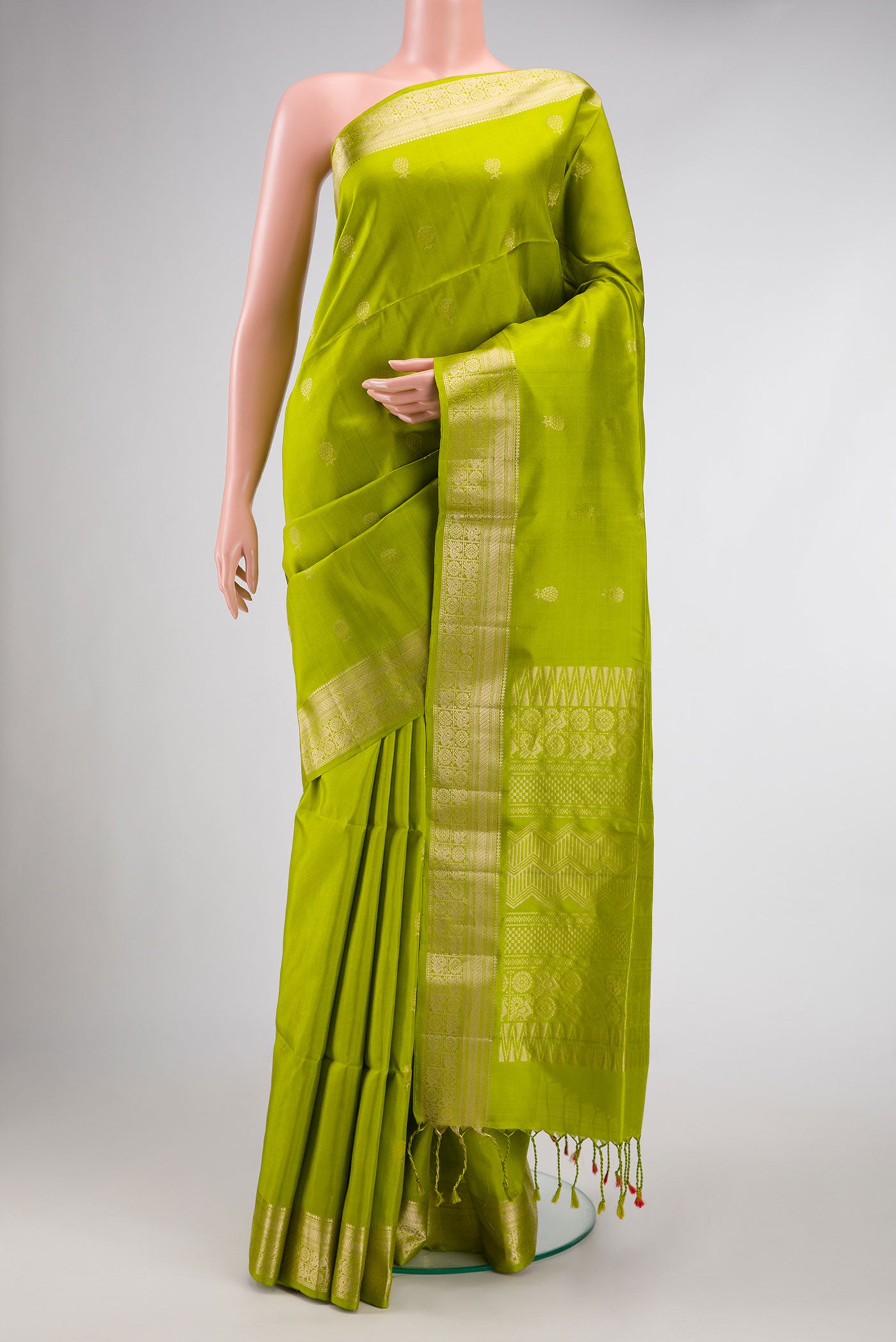 Parrot Green Dual Tone Soft Silk Saree with Zari Butta on the body and Zari Border.  displayed on a mannequin