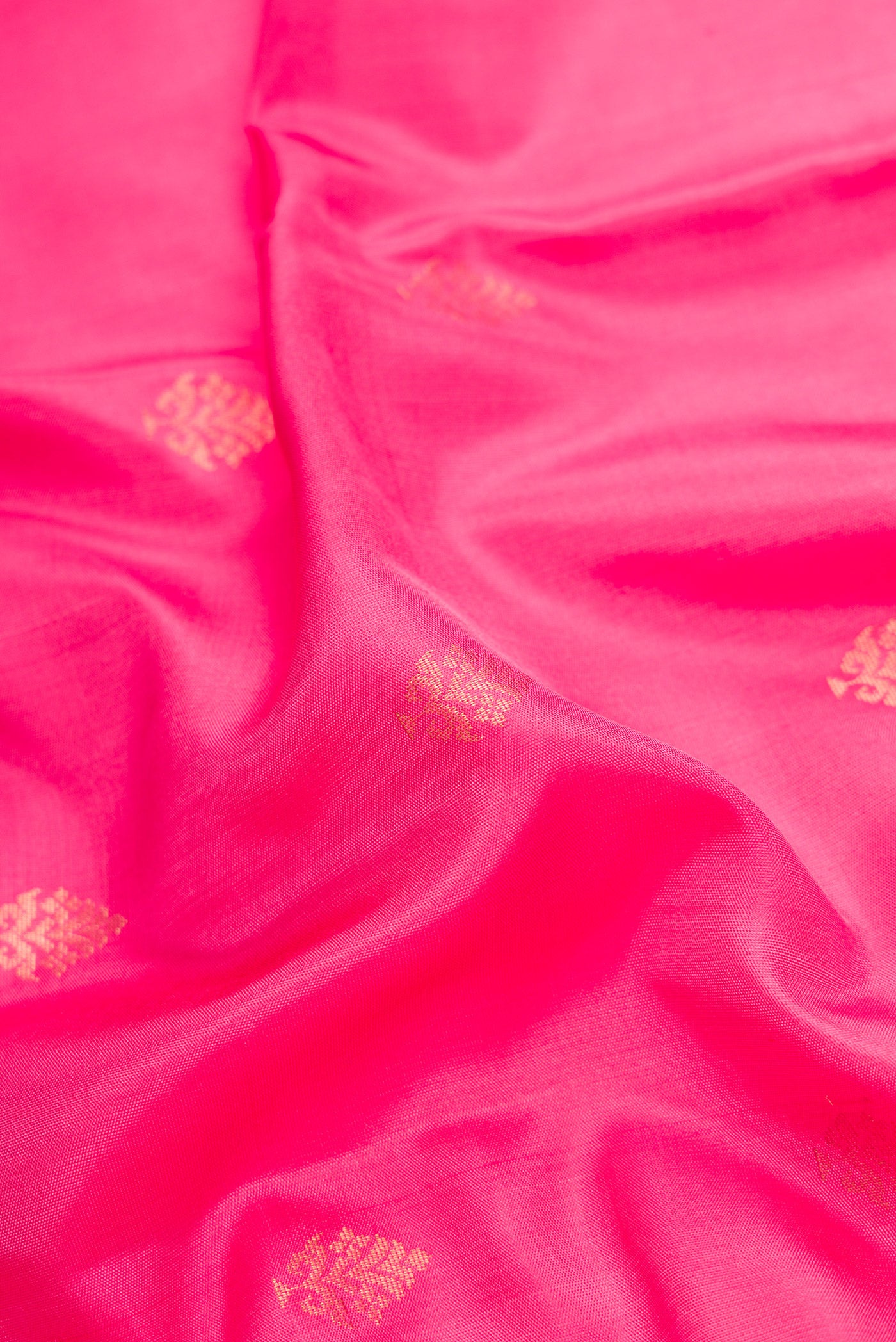 Close up of Pink Dual Tone Soft Silk Saree with Zari Butta on the body and Zari Border.  displaying folds