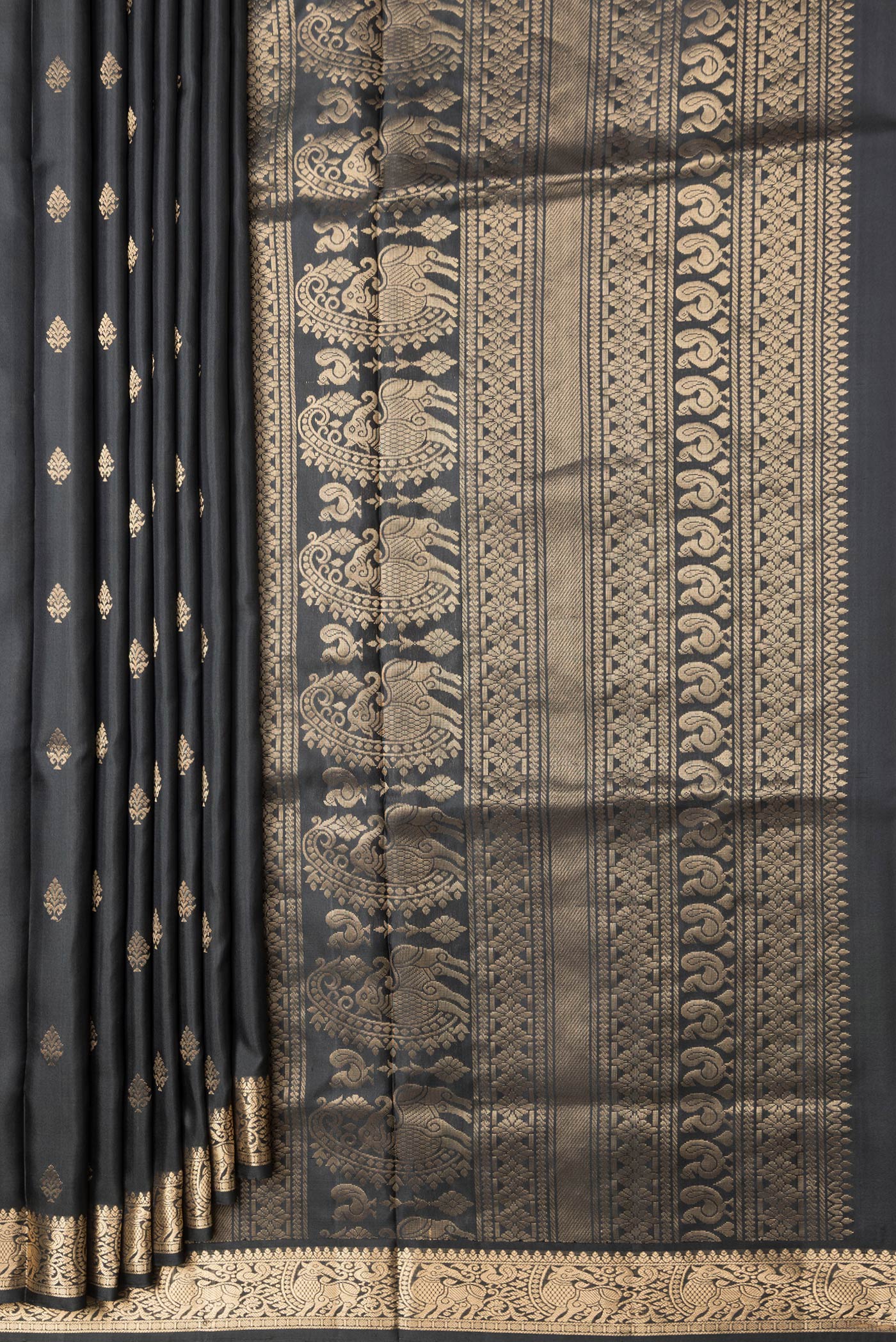 Pleats and pallu of Black Dual Tone Soft Silk Saree with Zari Butta on the body and Zari Border. 