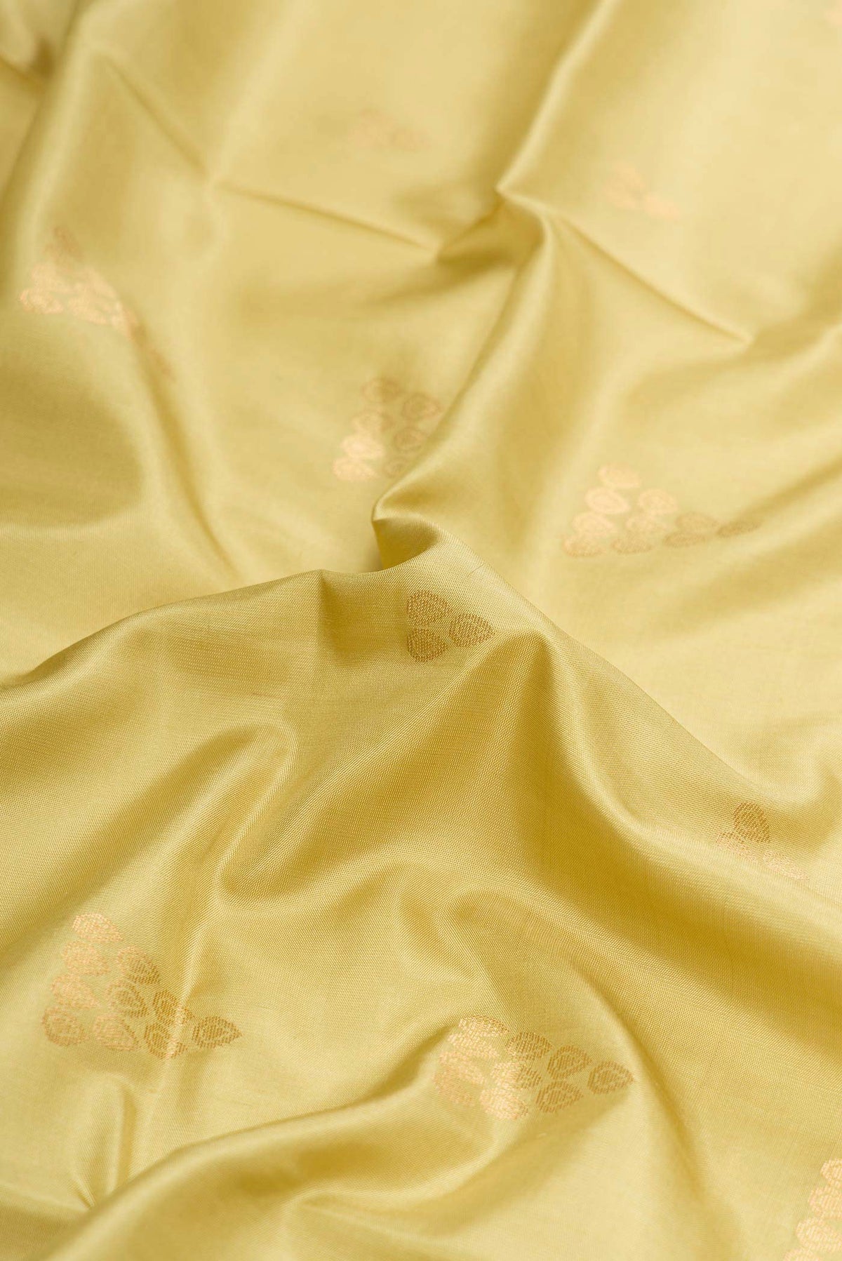 Close up of Pista Green Dual Tone Soft Silk Saree with Zari Butta on the body and Zari Border displaying folds