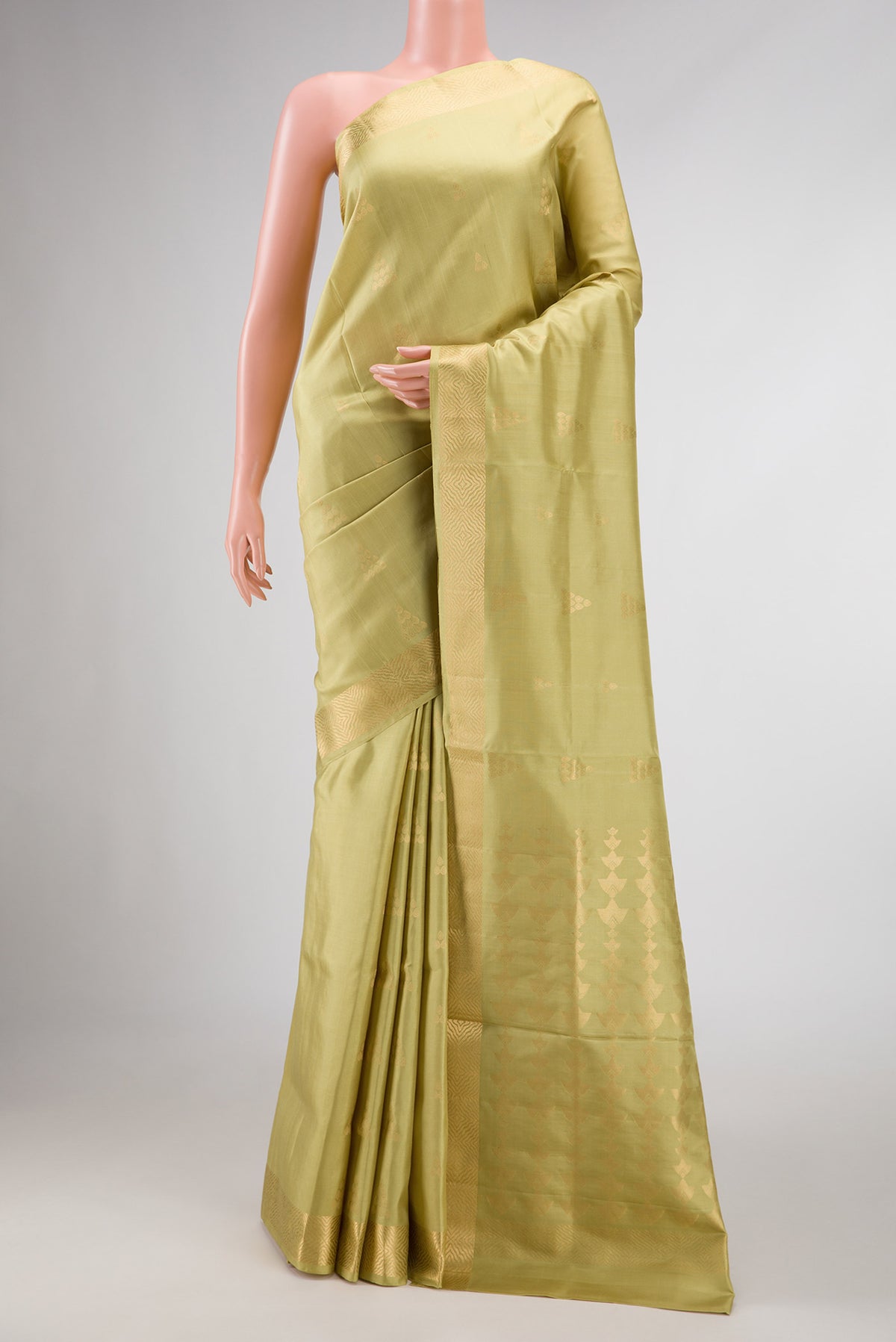 Pista Green Dual Tone Soft Silk Saree with Zari Butta on the body and Zari Border displayed on a mannequin