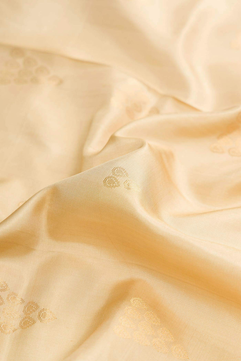Close up of Dark Beige Dual Tone Soft Silk Saree with Zari Butta on the body and Zari Border displaying folds