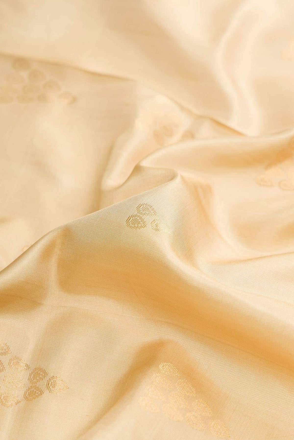 Close up of Dark Beige Dual Tone Soft Silk Saree with Zari Butta on the body and Zari Border displaying folds