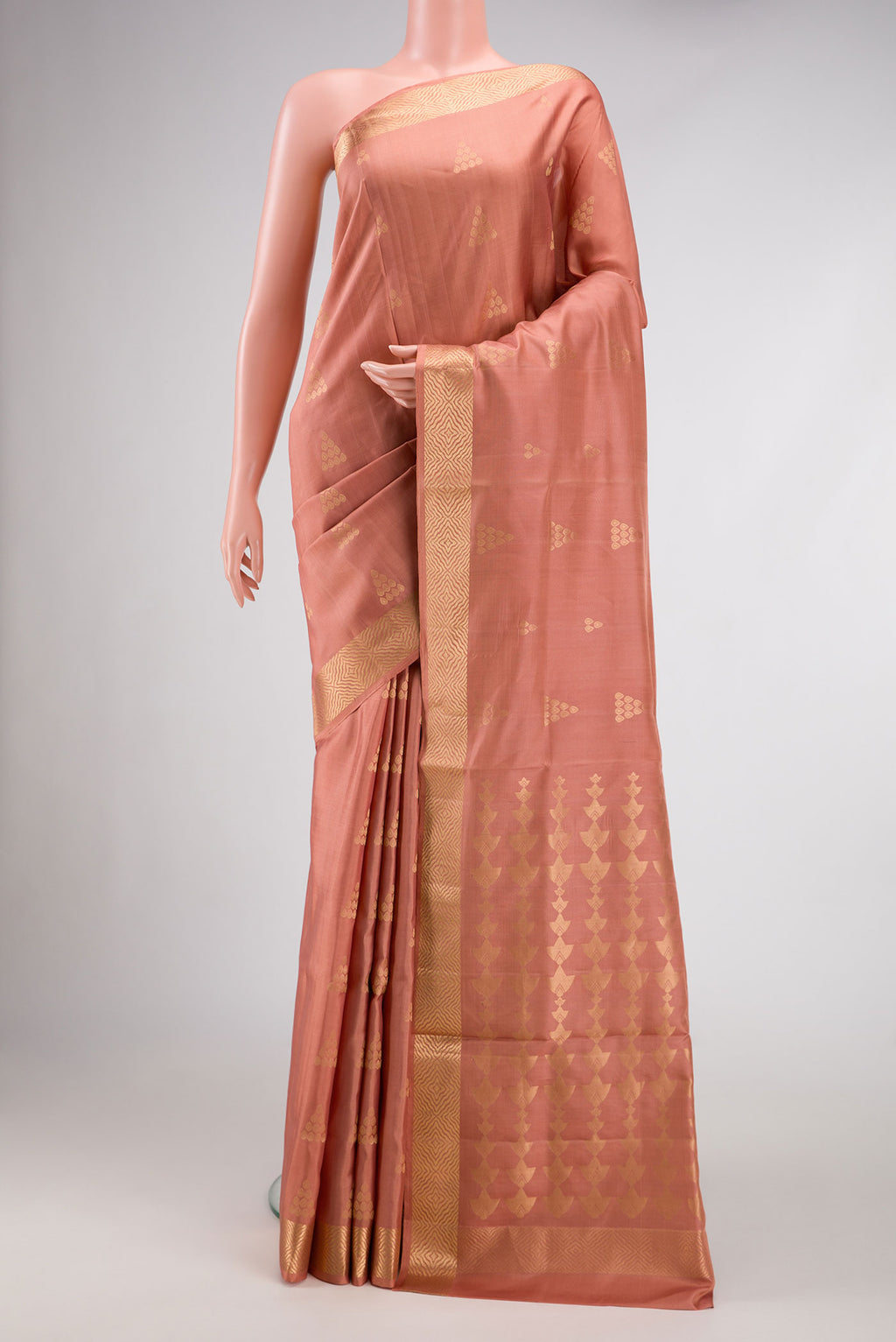 Golden Peach Dual Tone Soft Silk Saree with Zari Butta on the body and Zari Border.  displayed on a mannequin