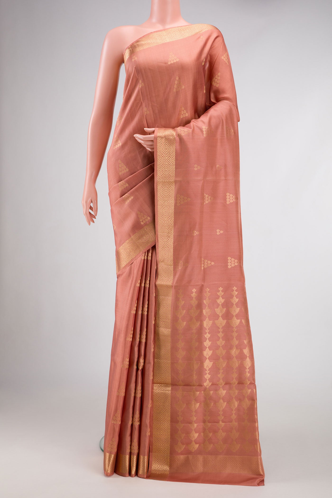 Golden Peach Dual Tone Soft Silk Saree with Zari Butta on the body and Zari Border.  displayed on a mannequin