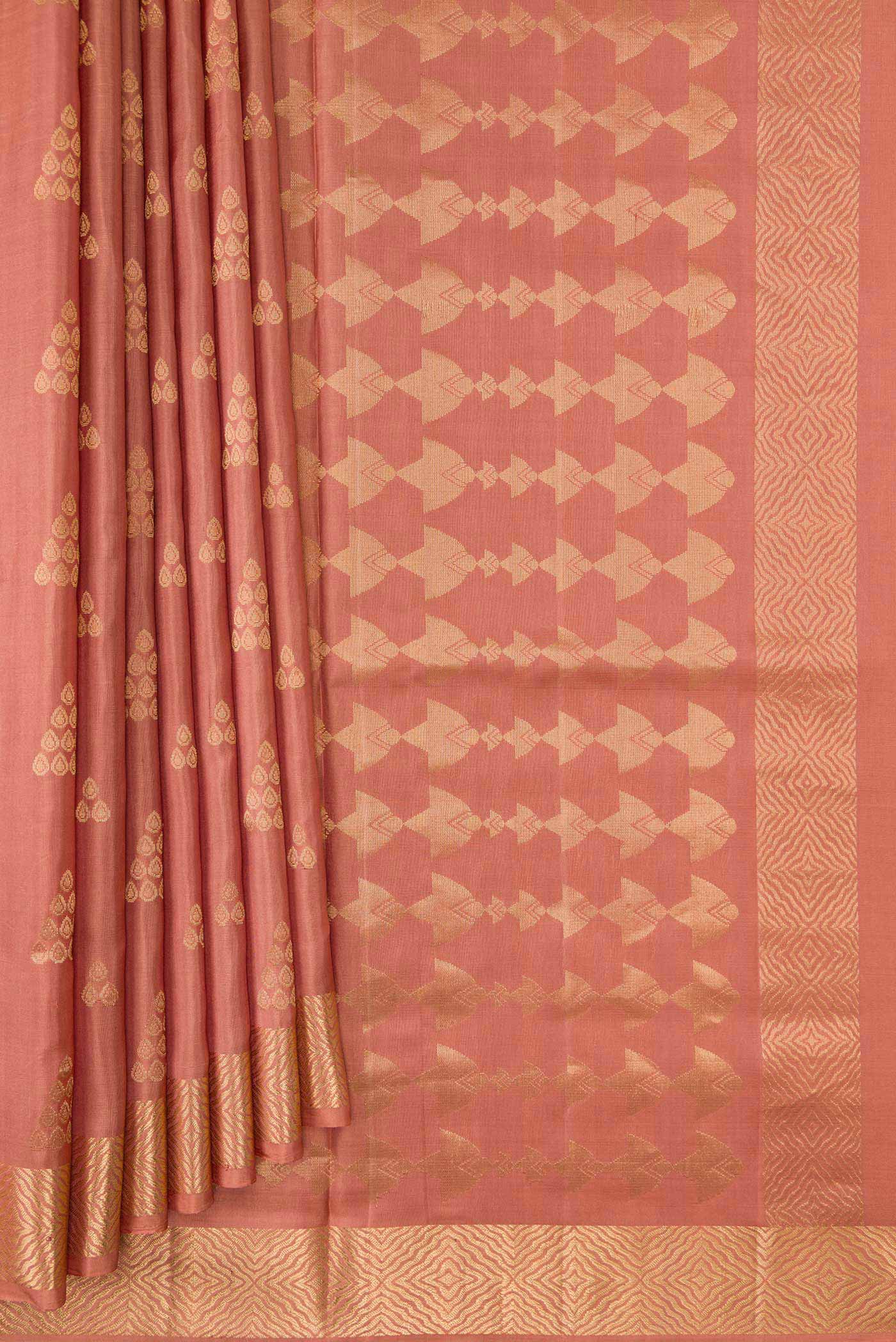 Pleats and pallu of Golden Peach Dual Tone Soft Silk Saree with Zari Butta on the body and Zari Border. 