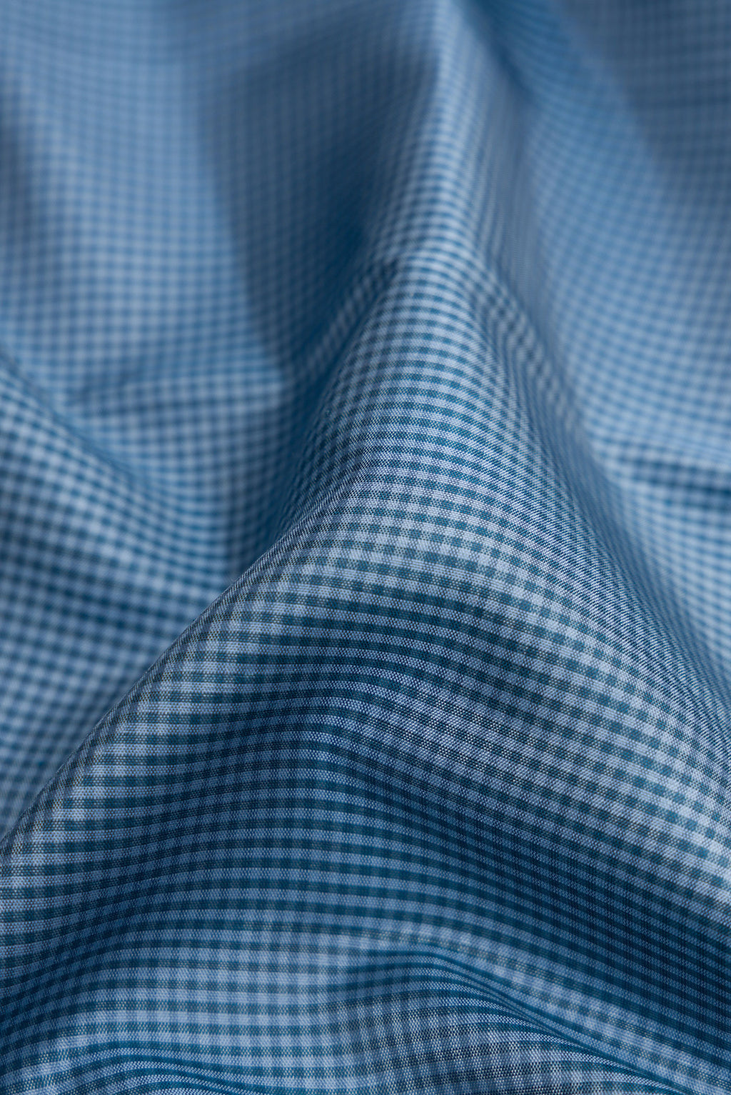 Close up of Blue Dual Tone Kanjivaram Silk Saree with Checked design on the body and Zari Border.  displaying folds