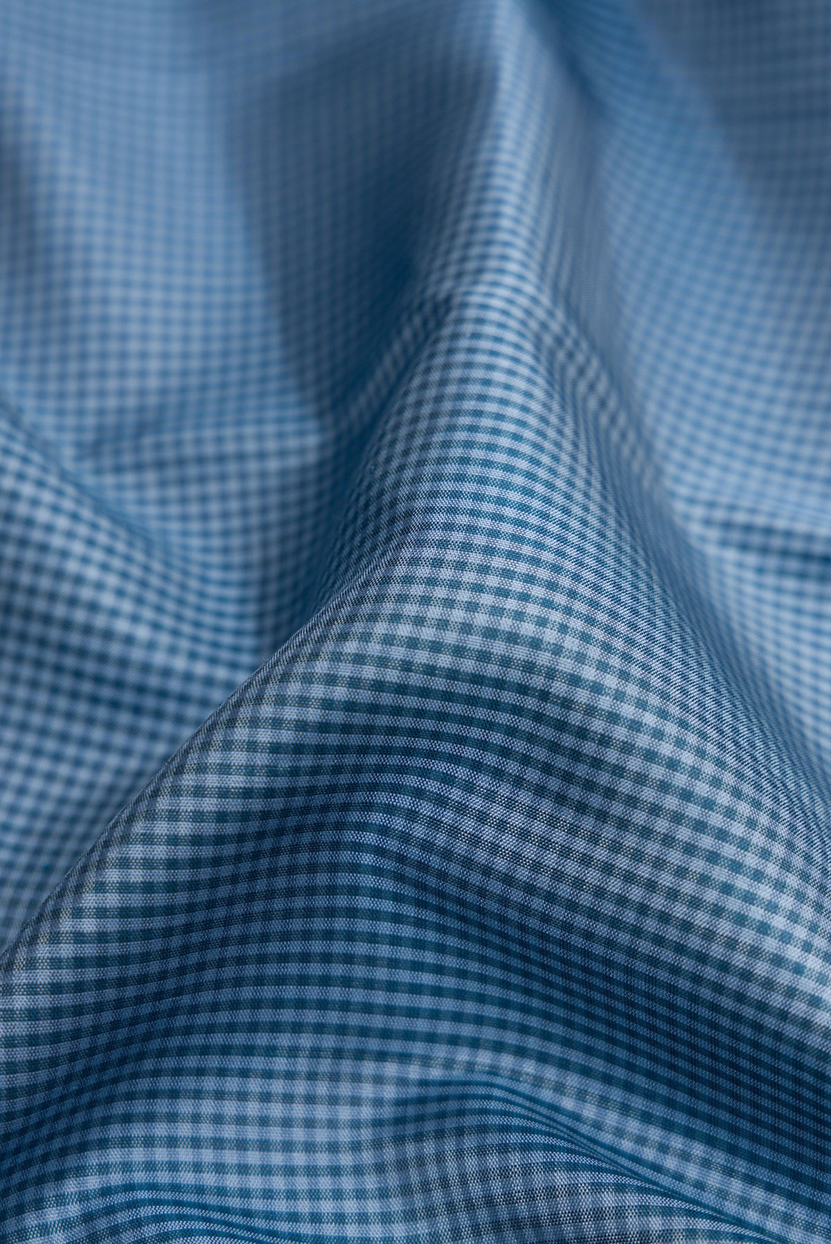 Close up of Blue Dual Tone Kanjivaram Silk Saree with Checked design on the body and Zari Border.  displaying folds