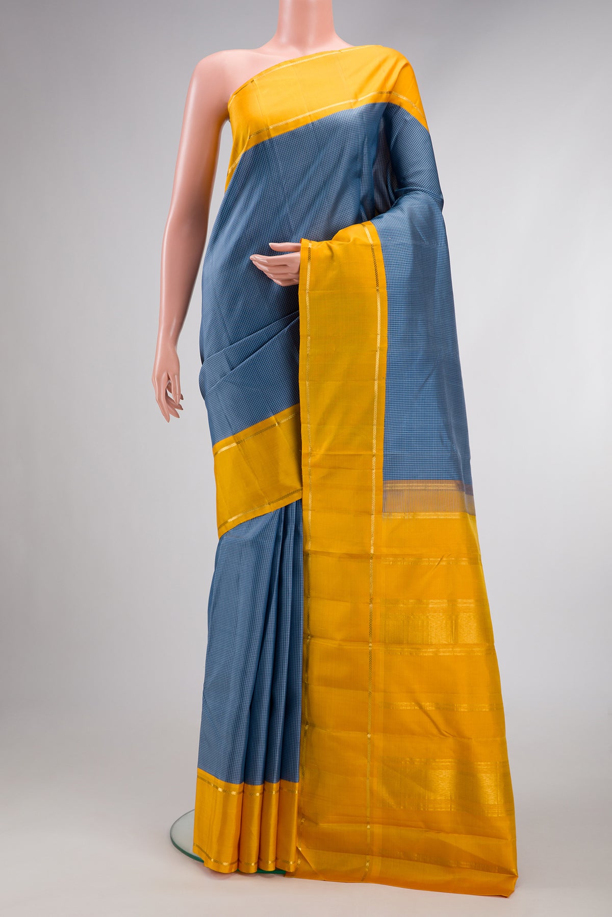 Blue Dual Tone Kanjivaram Silk Saree with Checked design on the body and Zari Border.  displayed on a mannequin