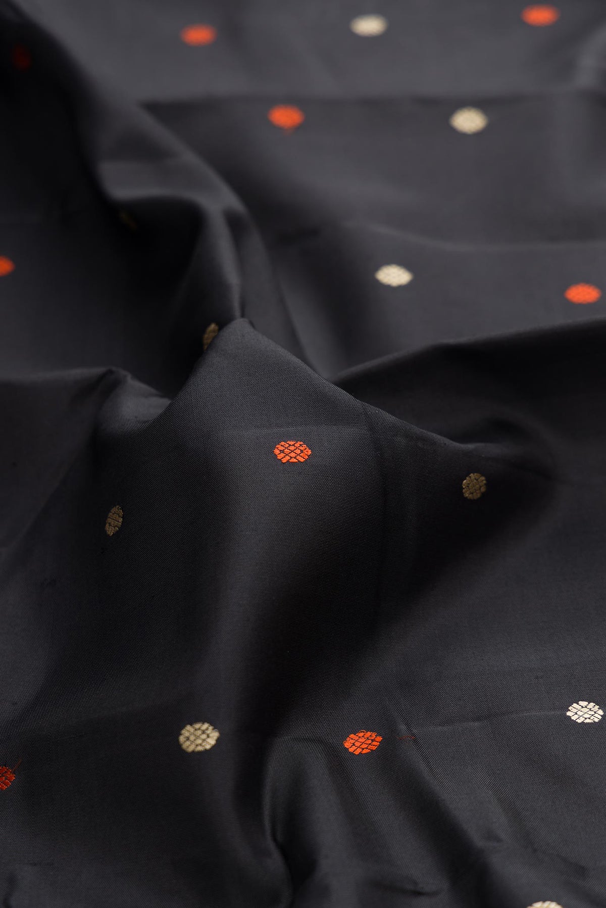 Close up of Black Dual Tone Kanchipuram Silk Saree with Thread Butta on the body and Thread Border displaying folds