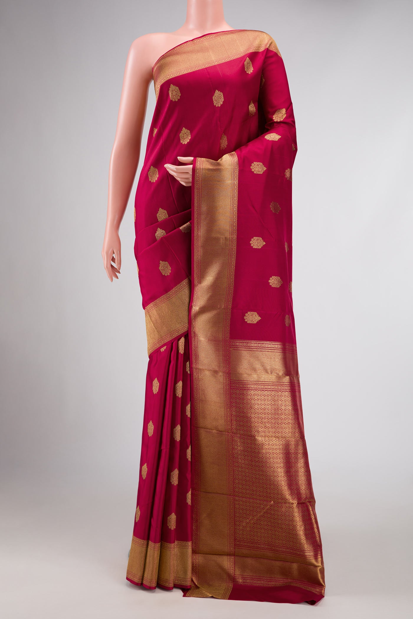 Pure Silk Pure Zari Maroon Dual Tone Kanjivaram Saree with Zari Butta on the body and Zari Border.  displayed on a mannequin