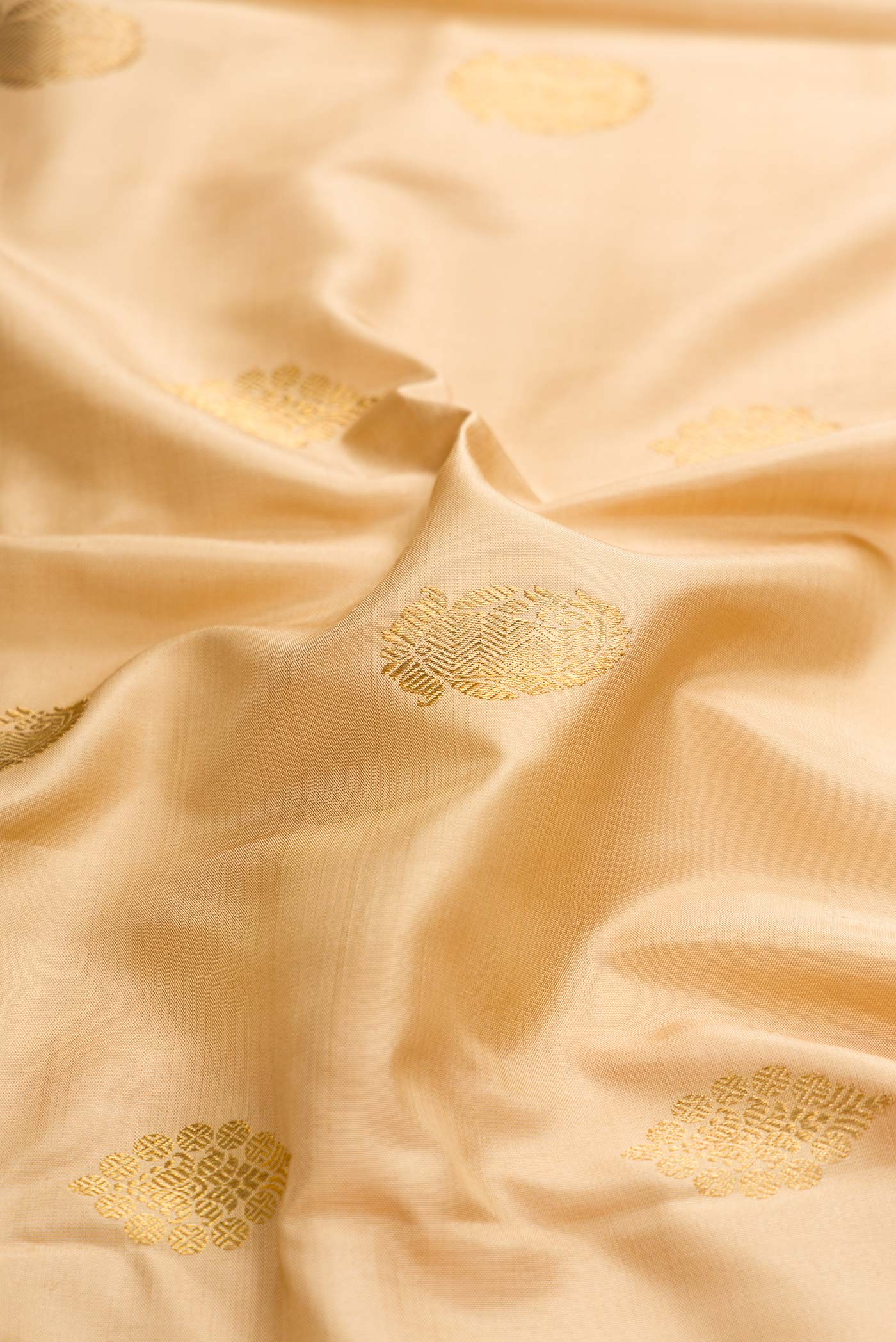 Close up of Pure Silk Pure Zari Dark Beige Dual Tone Kanchipuram Saree with Zari Butta on the body and Zari Border displaying folds
