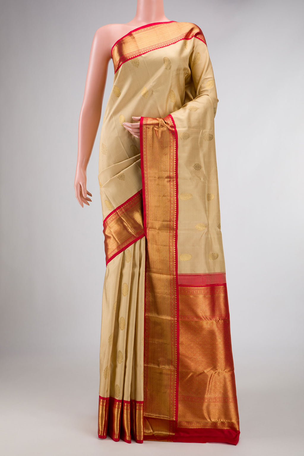 Pure Silk Pure Zari Dark Beige Dual Tone Kanchipuram Saree with Zari Butta on the body and Zari Border displayed on a mannequin