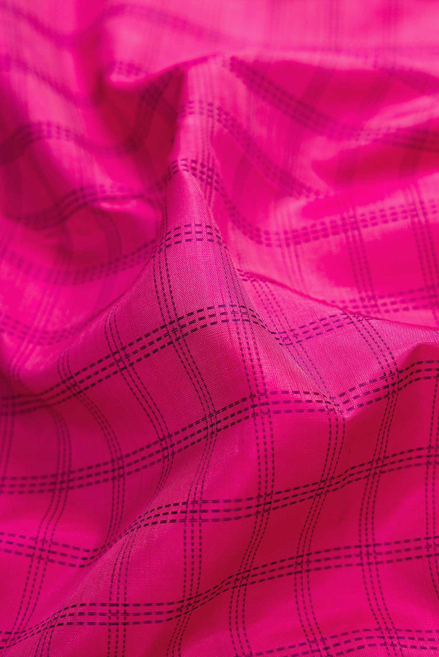 Close up of Pure Silk Pure Zari Pink Dual Tone Kanchipuram Saree with Checked design on the body and Zari Border displaying folds