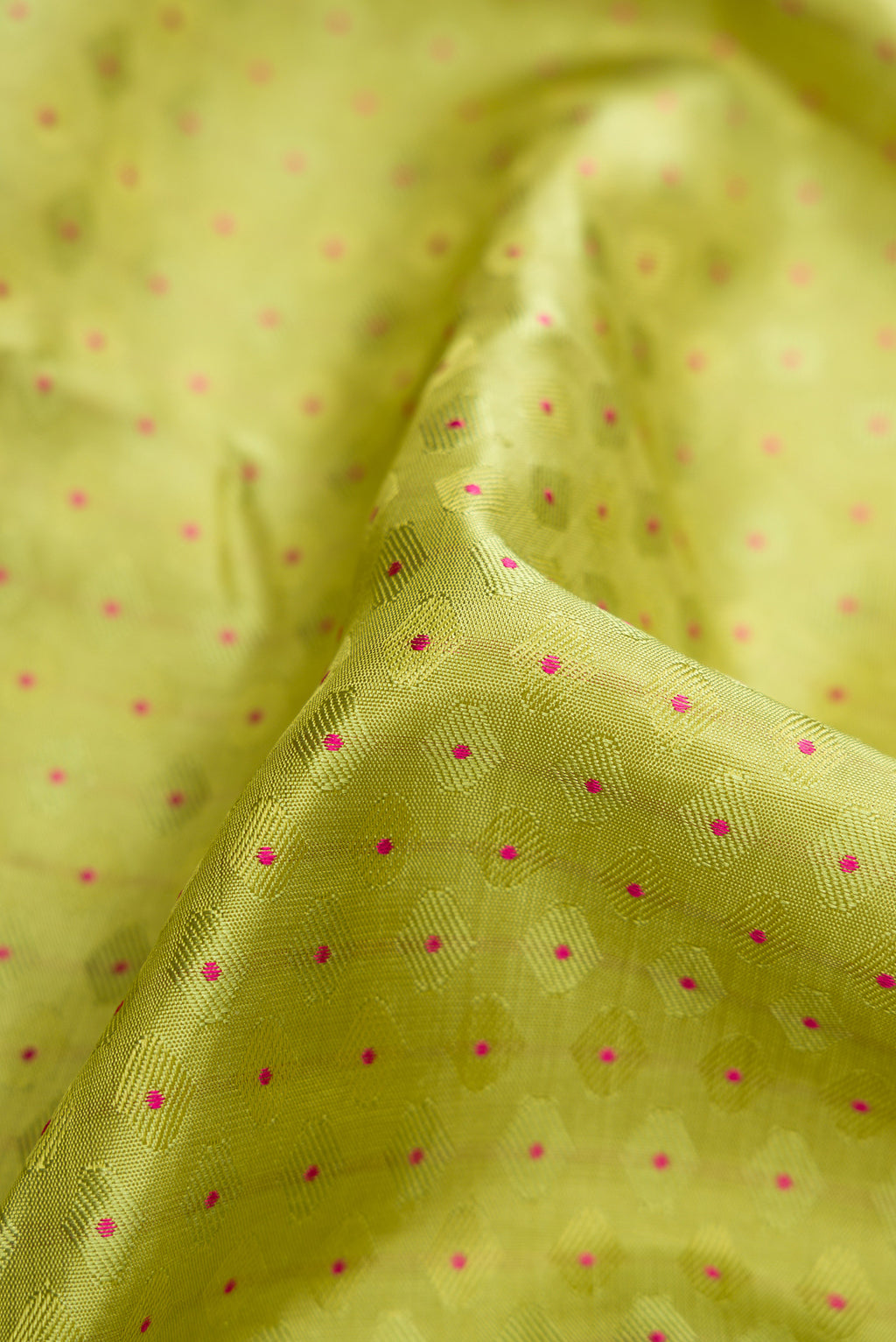 Close up of Pure Silk Pure Zari Parrot Green Dual Tone Kanchipuram Saree with Jacquard With Zari Butta on the body and Zari And Thread Border.  displaying folds