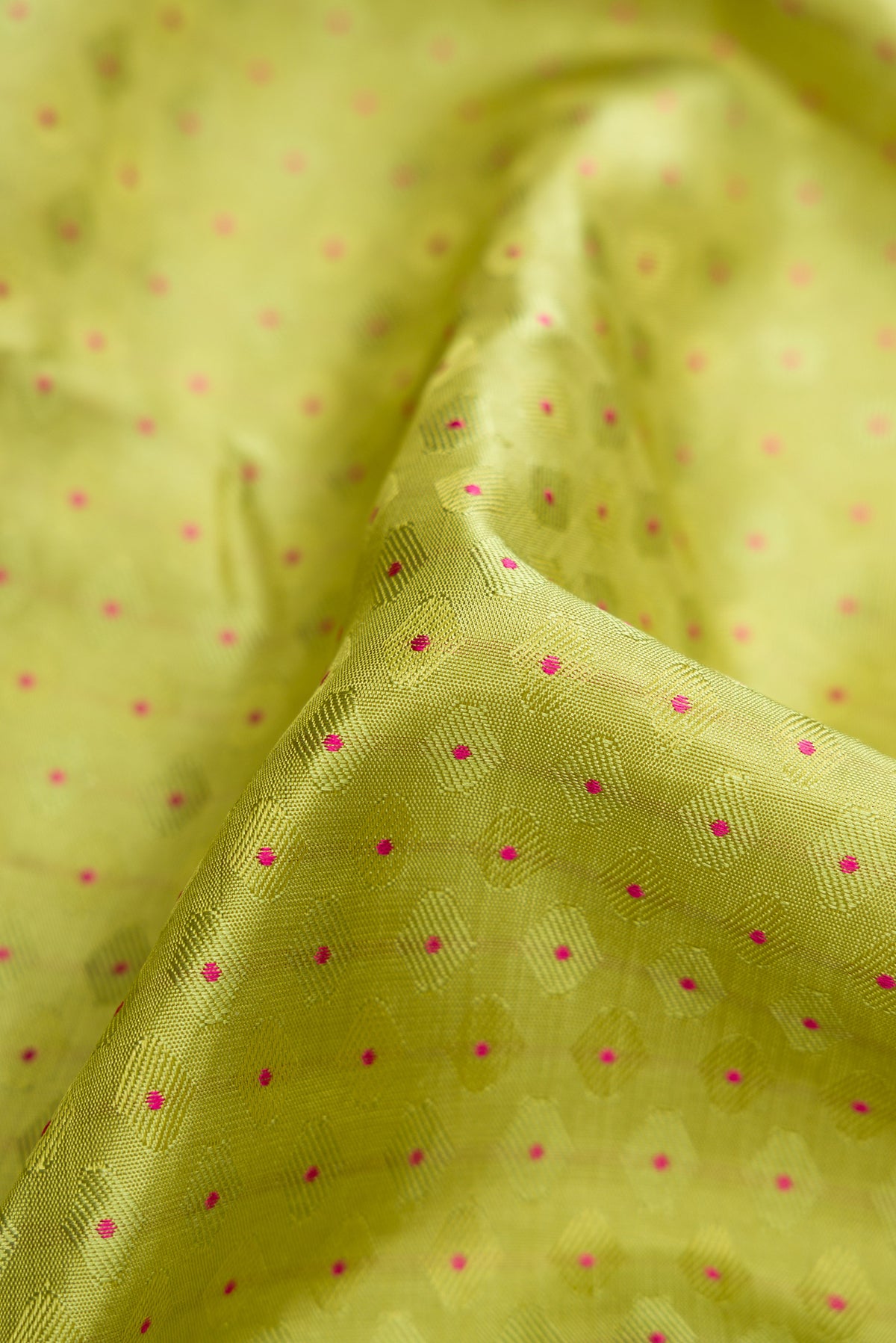 Close up of Pure Silk Pure Zari Parrot Green Dual Tone Kanchipuram Saree with Jacquard With Zari Butta on the body and Zari And Thread Border.  displaying folds