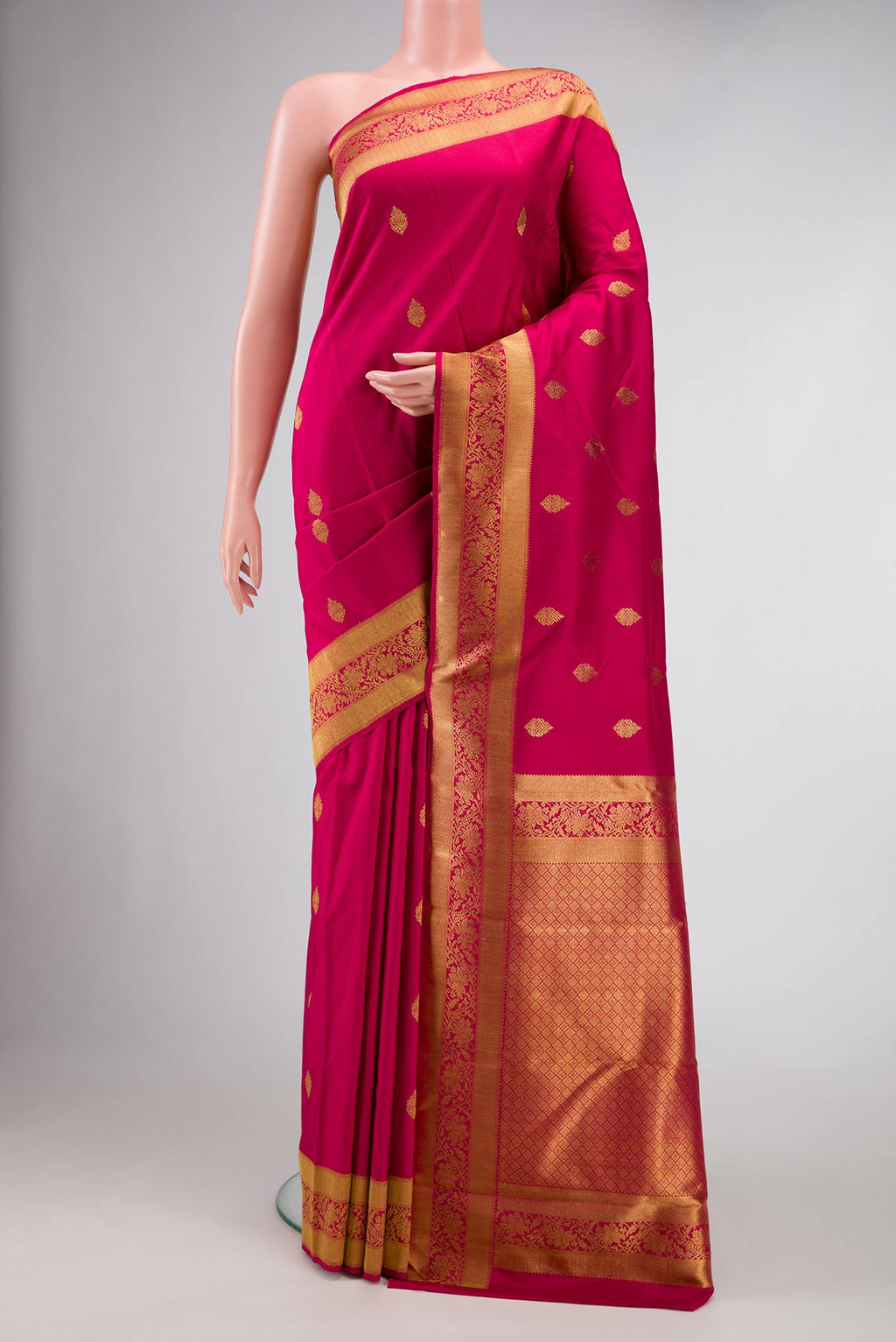 Pure Silk Pure Zari Dark Pink Dual Tone Kanjivaram Saree with Zari Butta on the body and Zari Border.  displayed on a mannequin