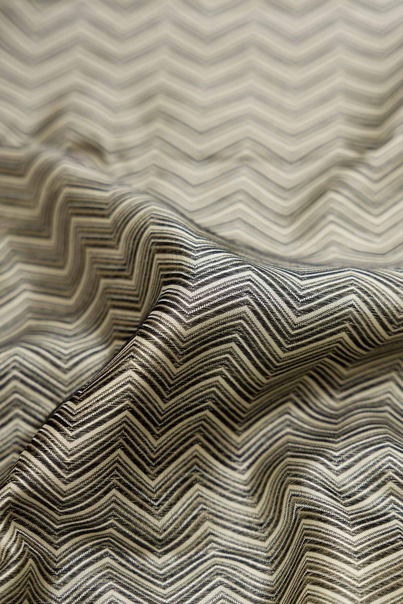 Close up of Pure Silk Pure Zari Grey Dual Tone Kanchipuram Saree with Jacquard design on the body and Zari Border displaying folds