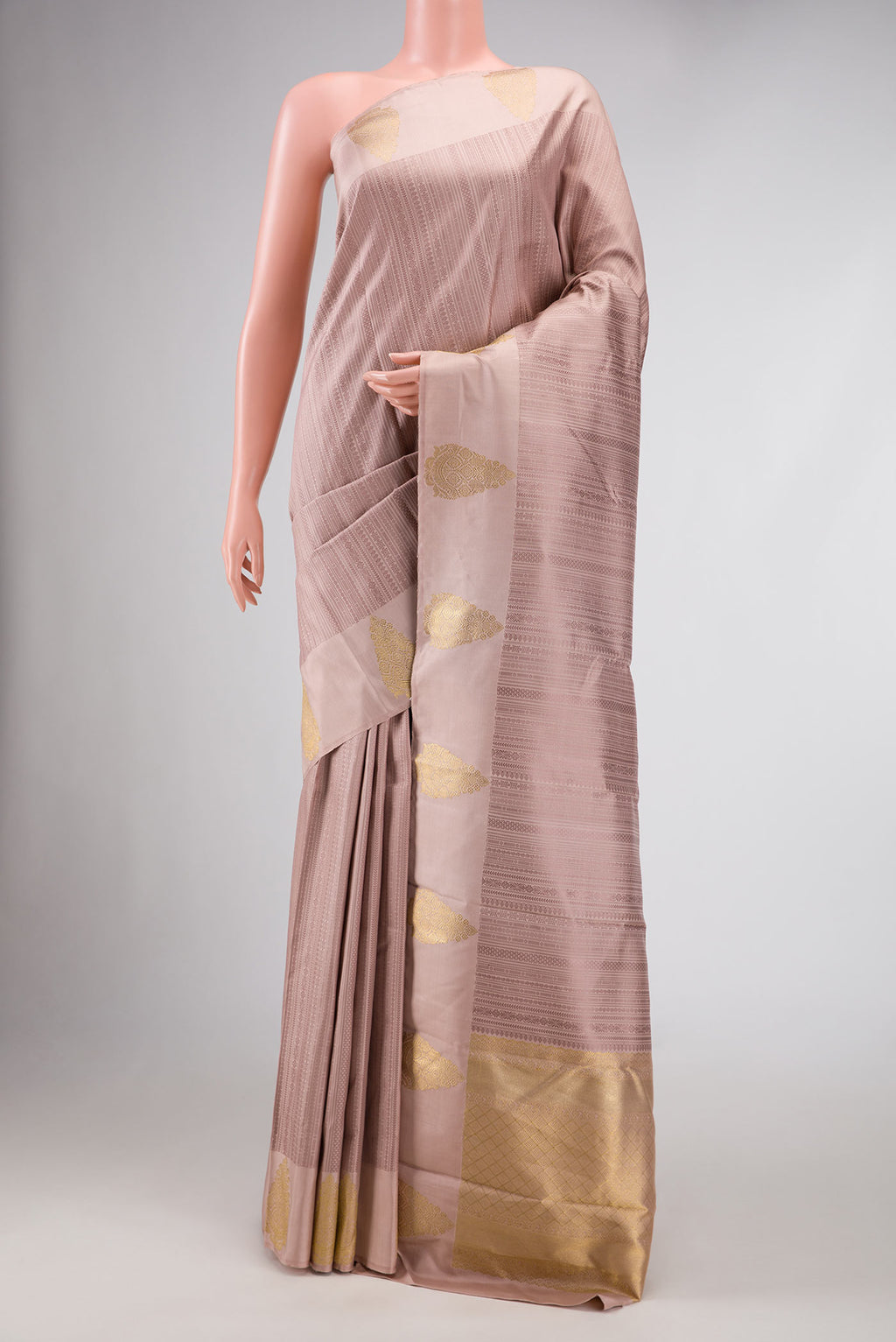 Pure Silk Pure Zari Rose Gold Dual Tone Kanchipuram Saree with Jacquard design on the body and Zari Border.  displayed on a mannequin