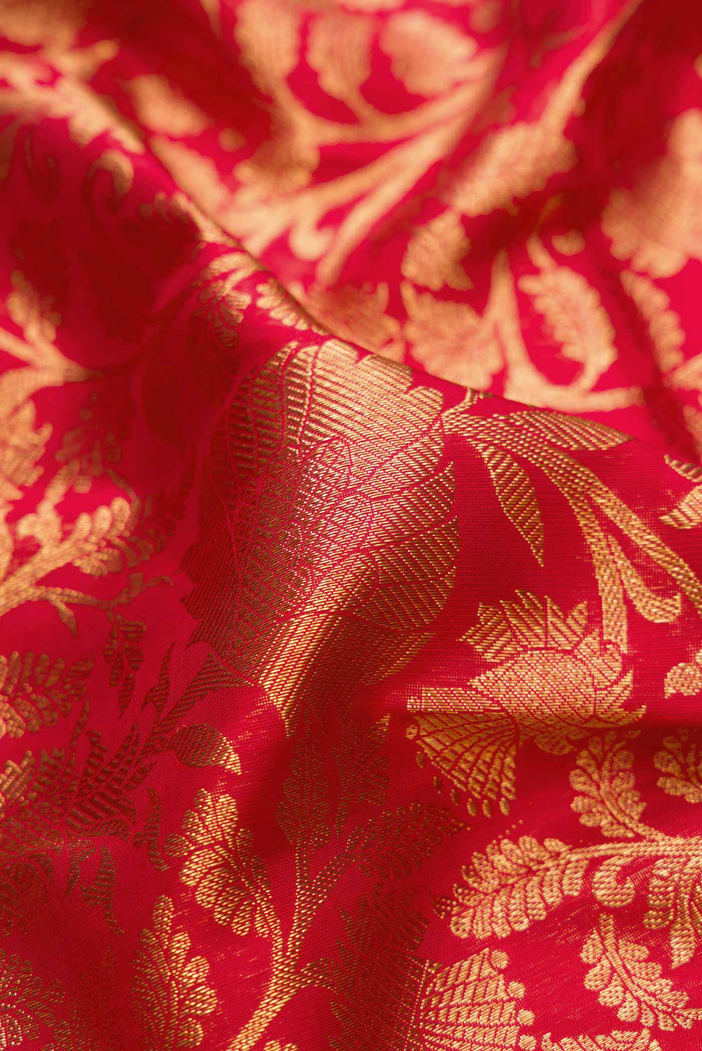 Close up of Pure Silk Pure Zari Red Dual Tone Kanchipuram Saree with Zari Brocade on the body and Zari Border displaying folds