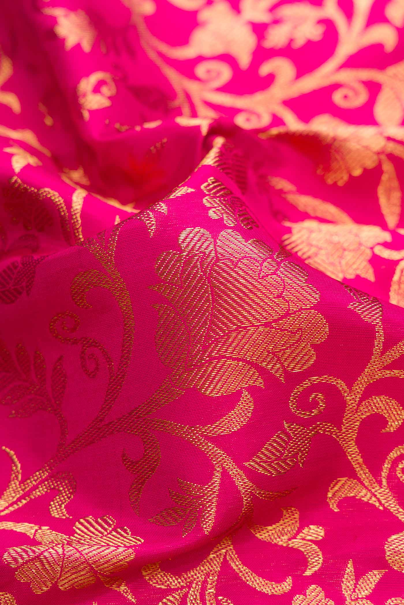 Close up of Pure Silk Pure Zari Pink Dual Tone Kanchipuram Saree with Zari Brocade on the body and Zari Border displaying folds