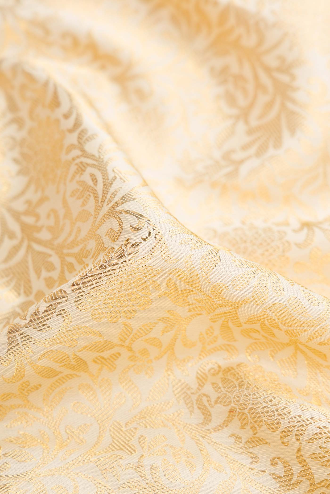 Close up of Pure Silk Pure Zari Off White Dual Tone Kanchipuram Saree with Zari Brocade on the body and Zari Border displaying folds
