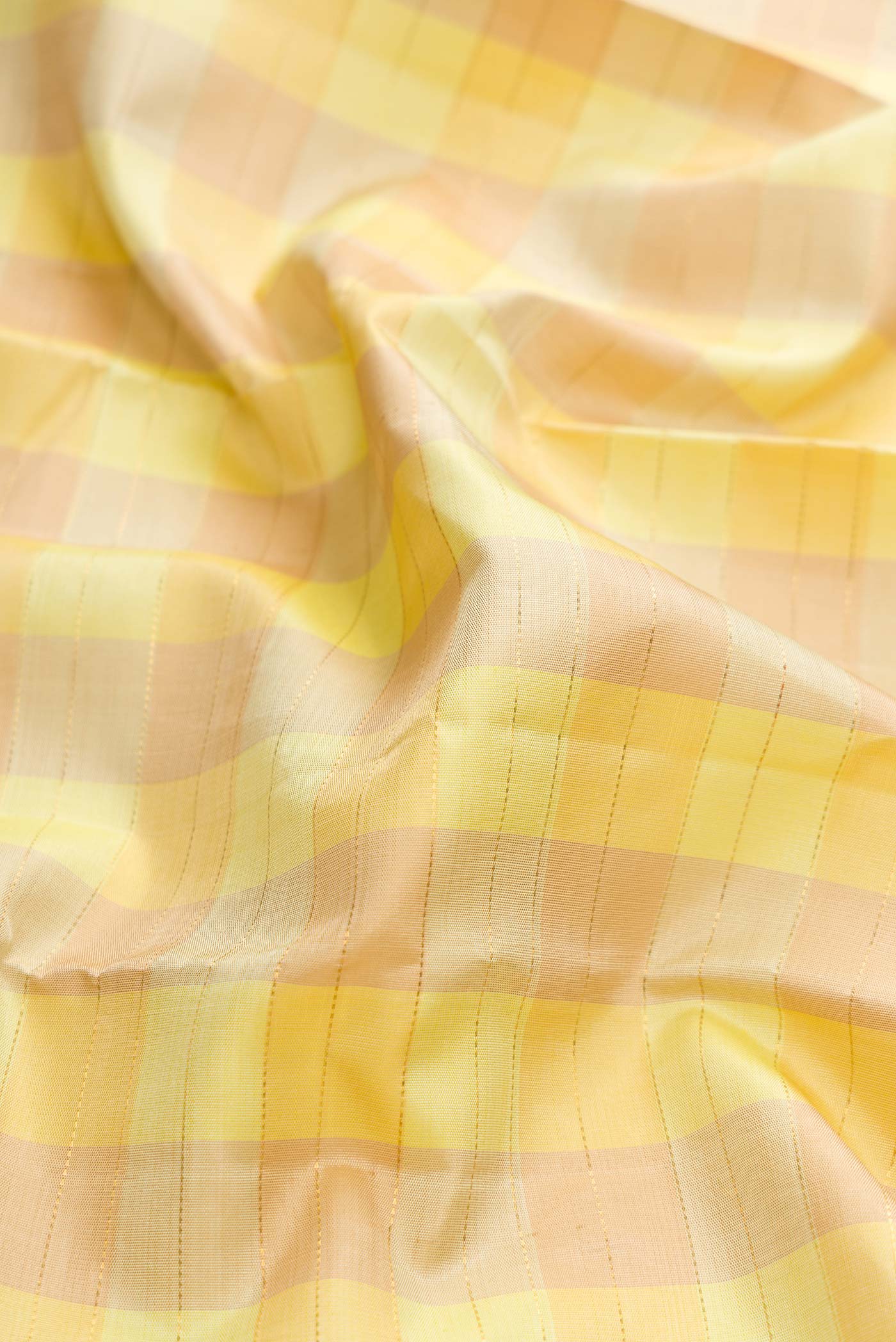 Close up of Pure Silk Pure Zari Lemon Yellow and Mustard Color Kanchipuram Saree with Checked design on the body and Zari Border displaying folds