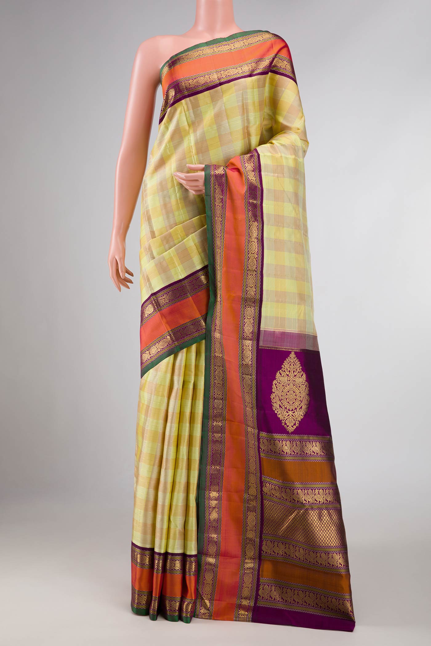 Pure Silk Pure Zari Lemon Yellow and Mustard Color Kanchipuram Saree with Checked design on the body and Zari Border displayed on a mannequin