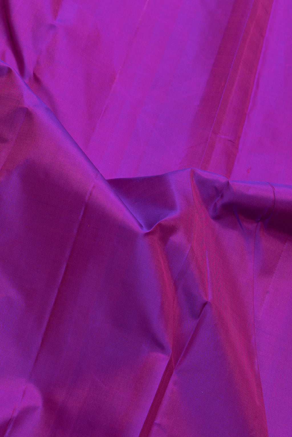 Close up of Purple Dual Tone Kanchipuram Silk Saree with Plain Body and Zari Border.  displaying folds